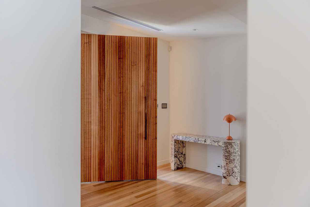 Wooden pivot door in a private home in Canberra with FritsJurgens System M+ pivot hinge system inside