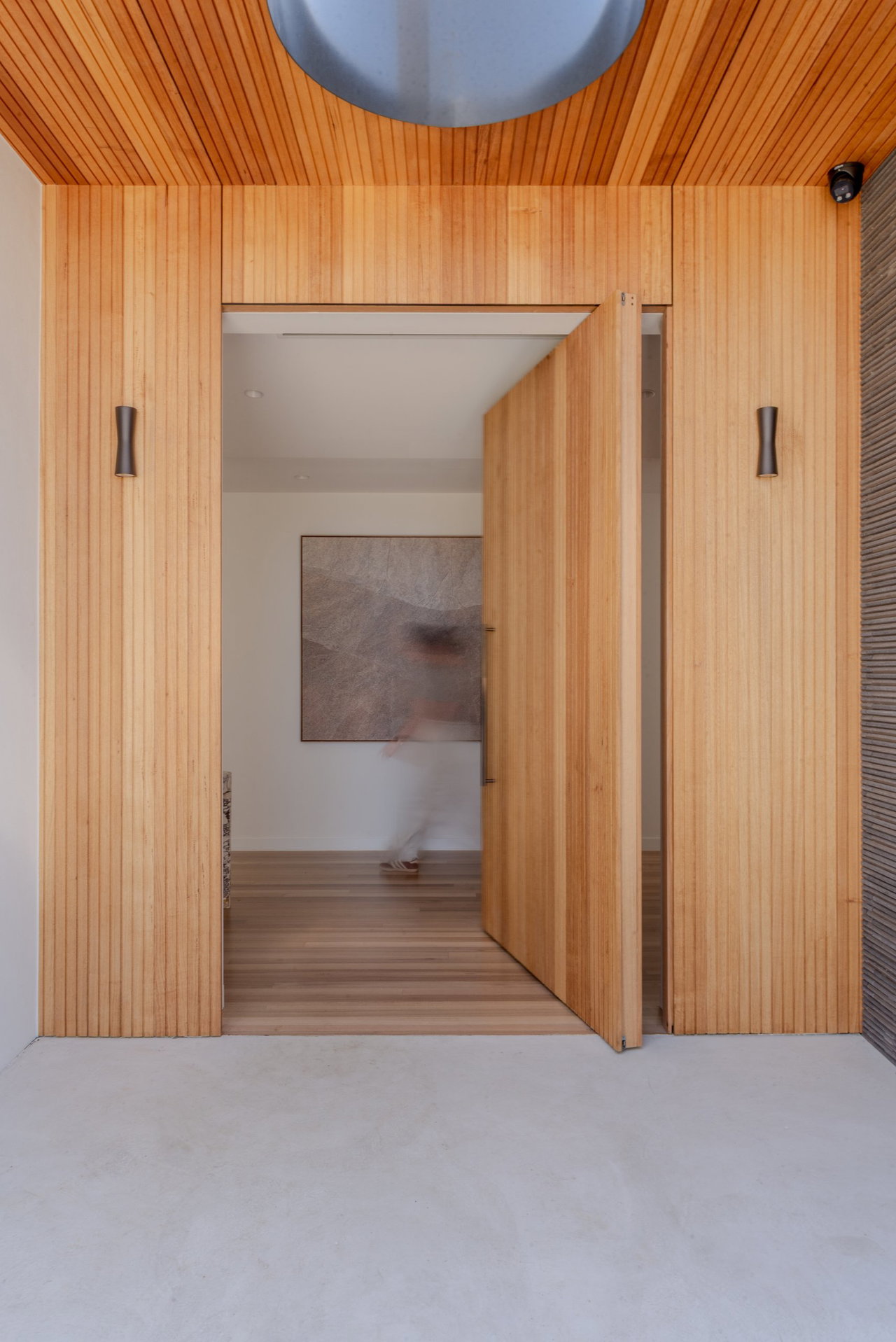 Wooden pivot door in a private home in Canberra with FritsJurgens System M+ pivot hinge system inside