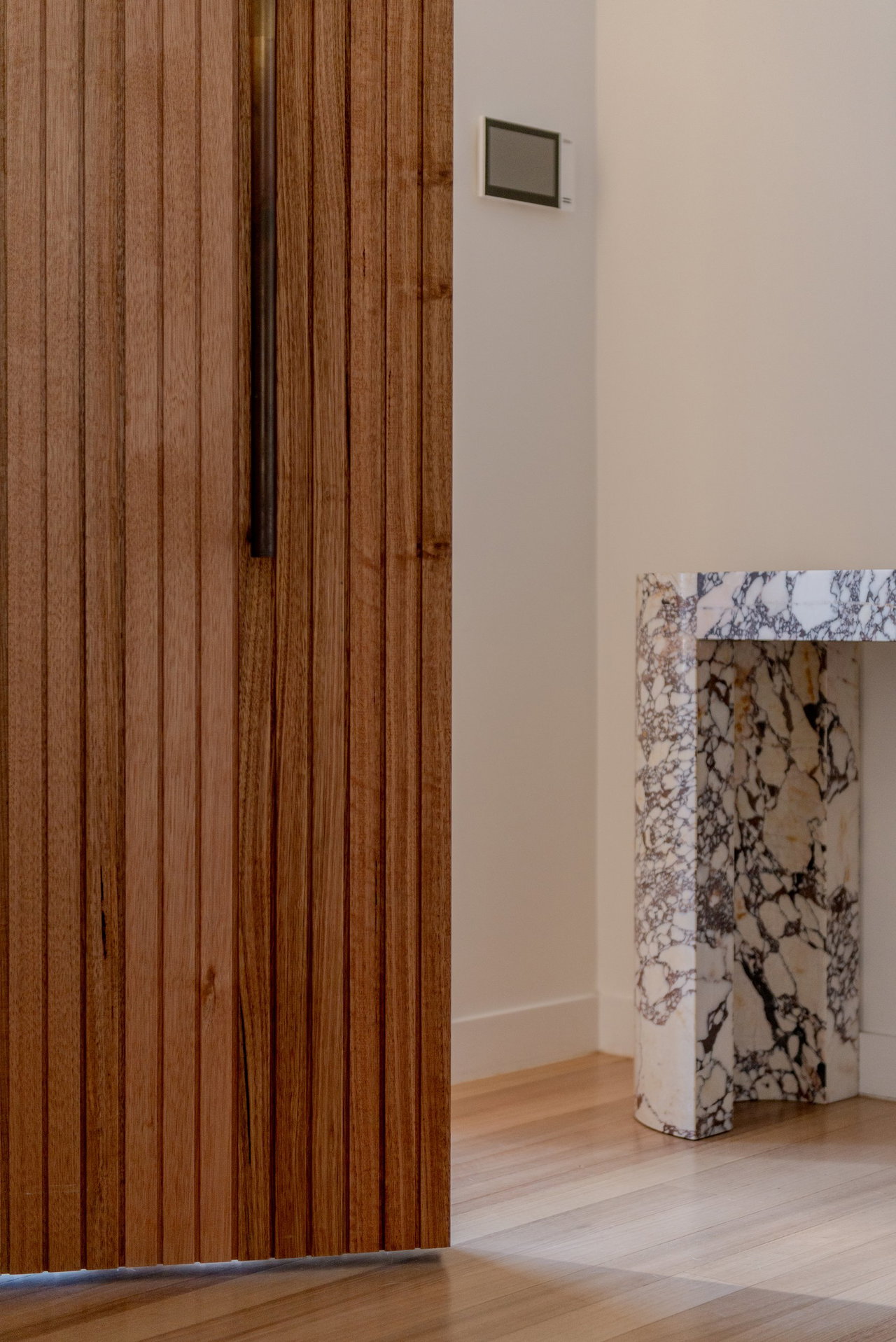 Wooden pivot door in a private home in Canberra with FritsJurgens System M+ pivot hinge system inside
