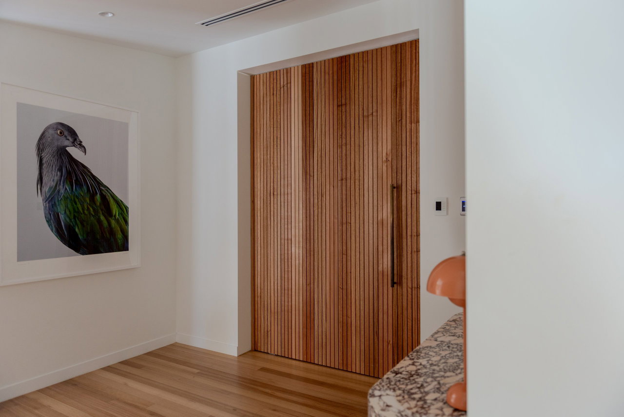 Wooden pivot door in a private home in Canberra with FritsJurgens System M+ pivot hinge system inside