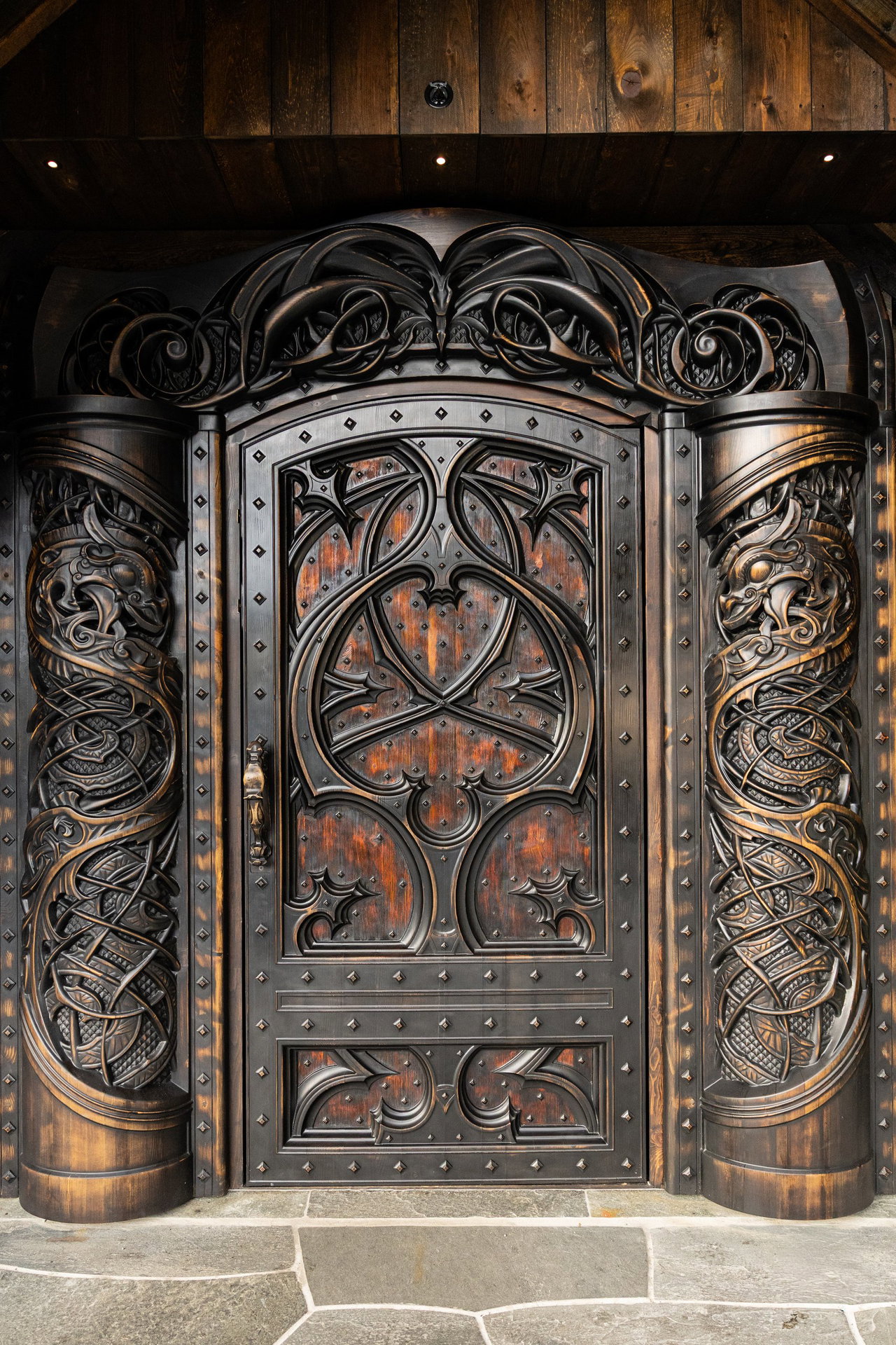 Wooden pivot door in a religious building in Odda with FritsJurgens System M+ pivot hinge system inside