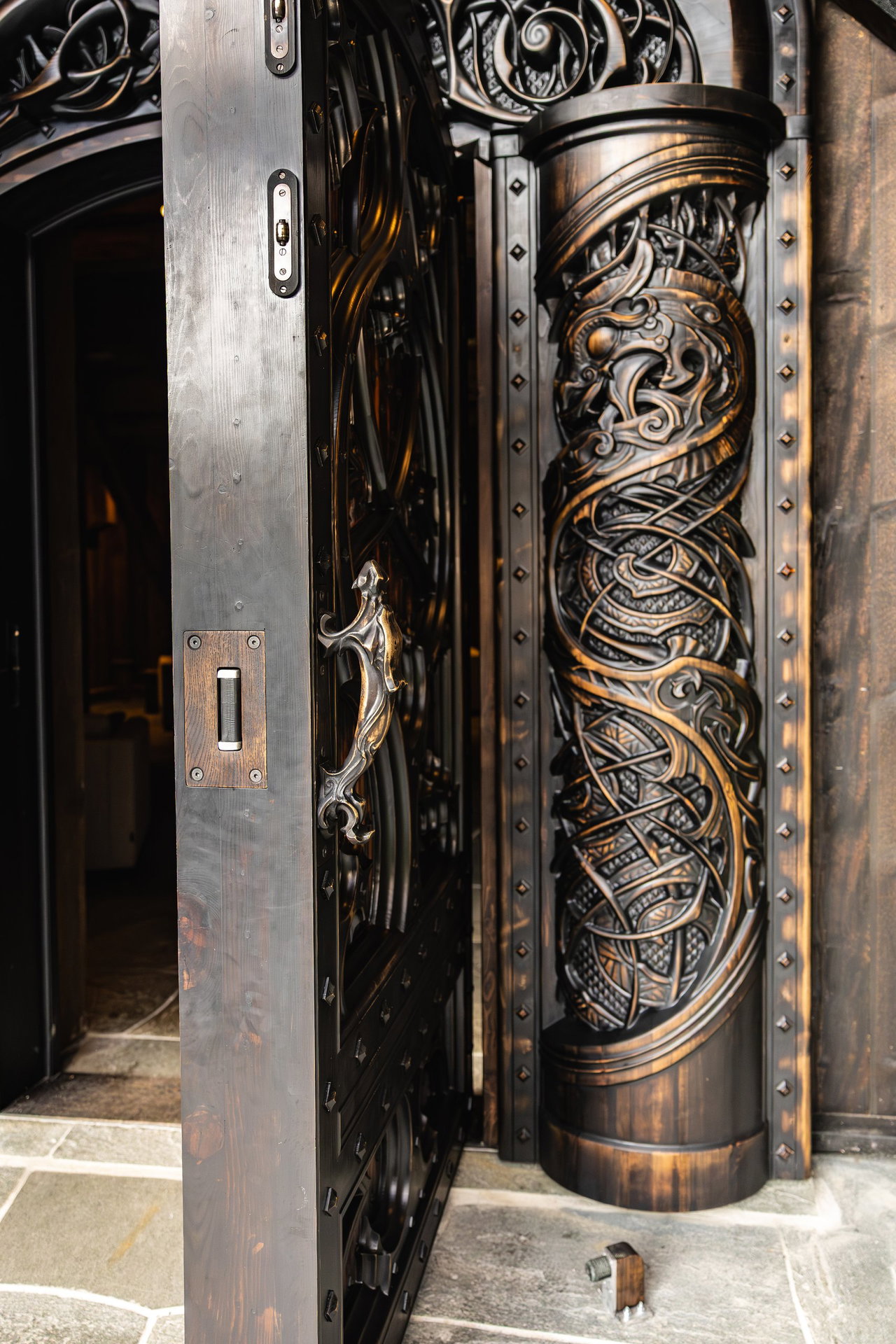 Wooden pivot door in a religious building in Odda with FritsJurgens System M+ pivot hinge system inside