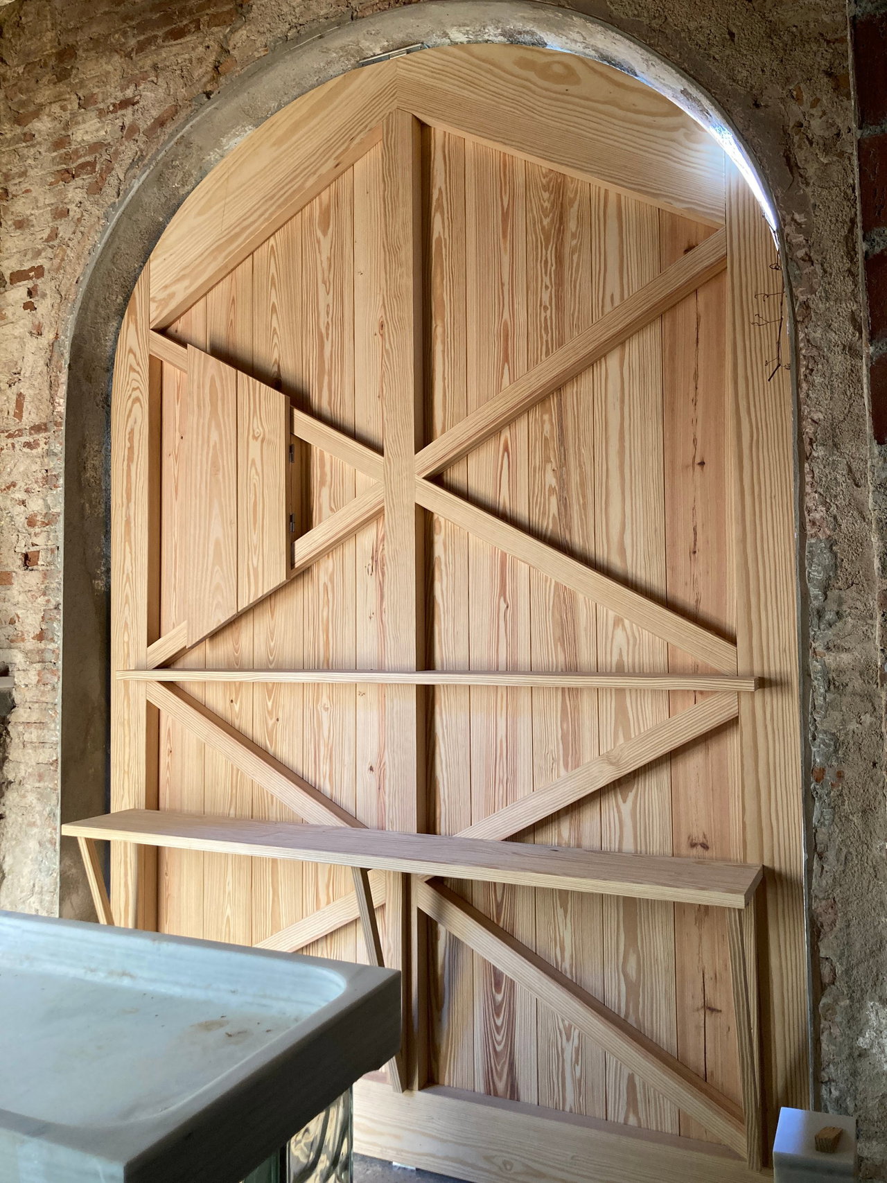 Wooden pivot door in a private home in Barcelona with FritsJurgens System One pivot hinge system inside