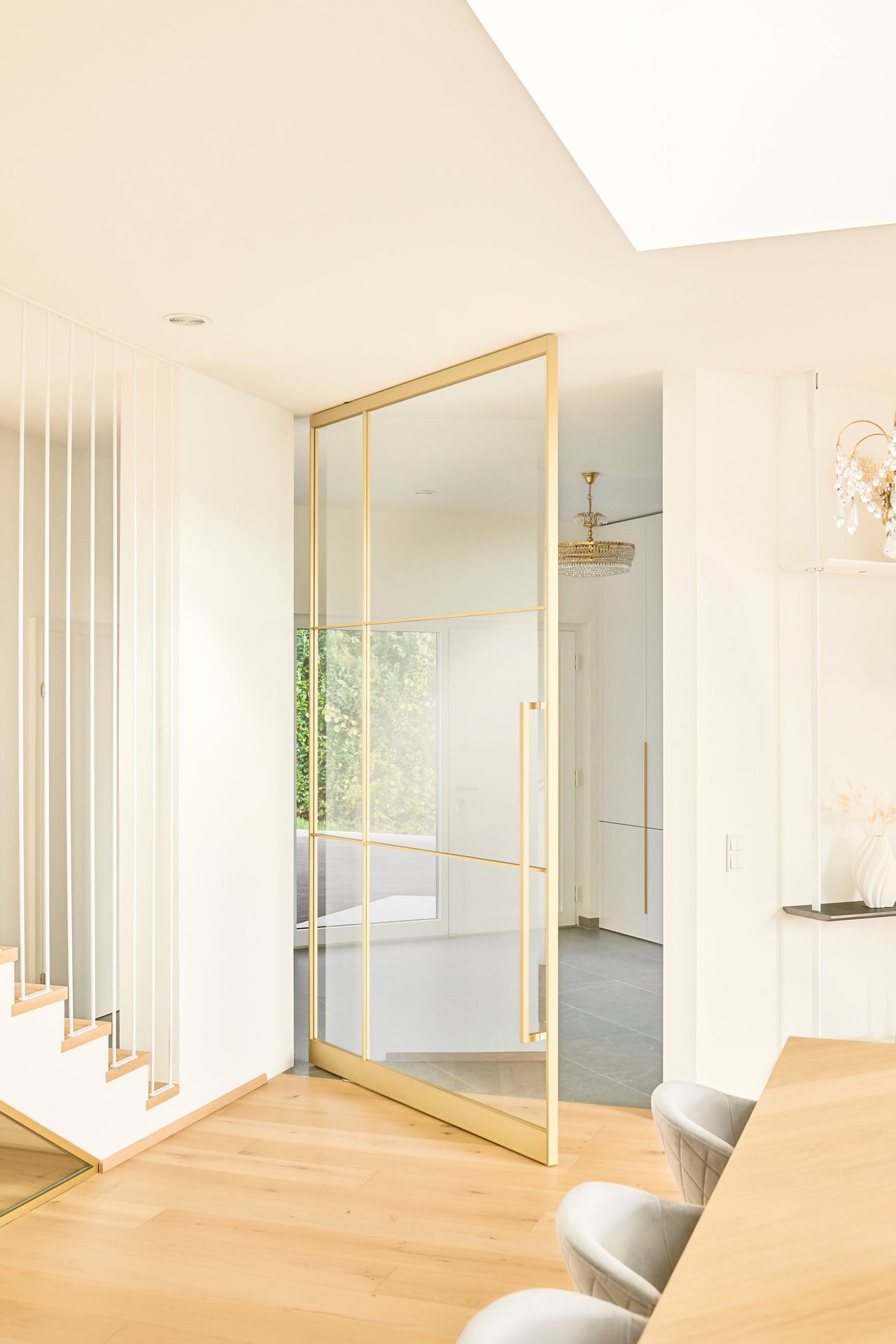 Steel and glass pivot door in a private home in Graz with FritsJurgens System M pivot hinge system inside