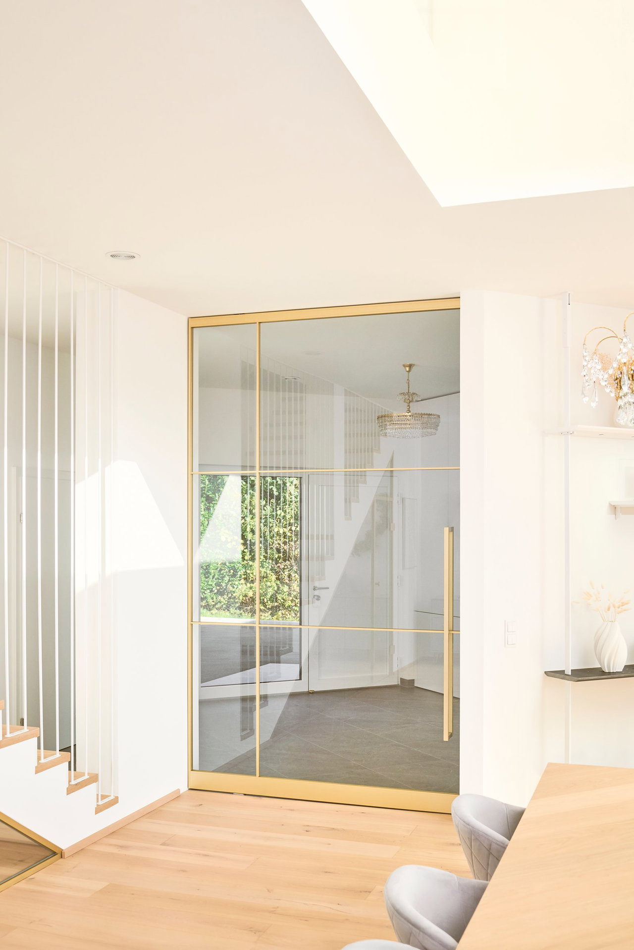 Steel and glass pivot door in a private home in Graz with FritsJurgens System M pivot hinge system inside