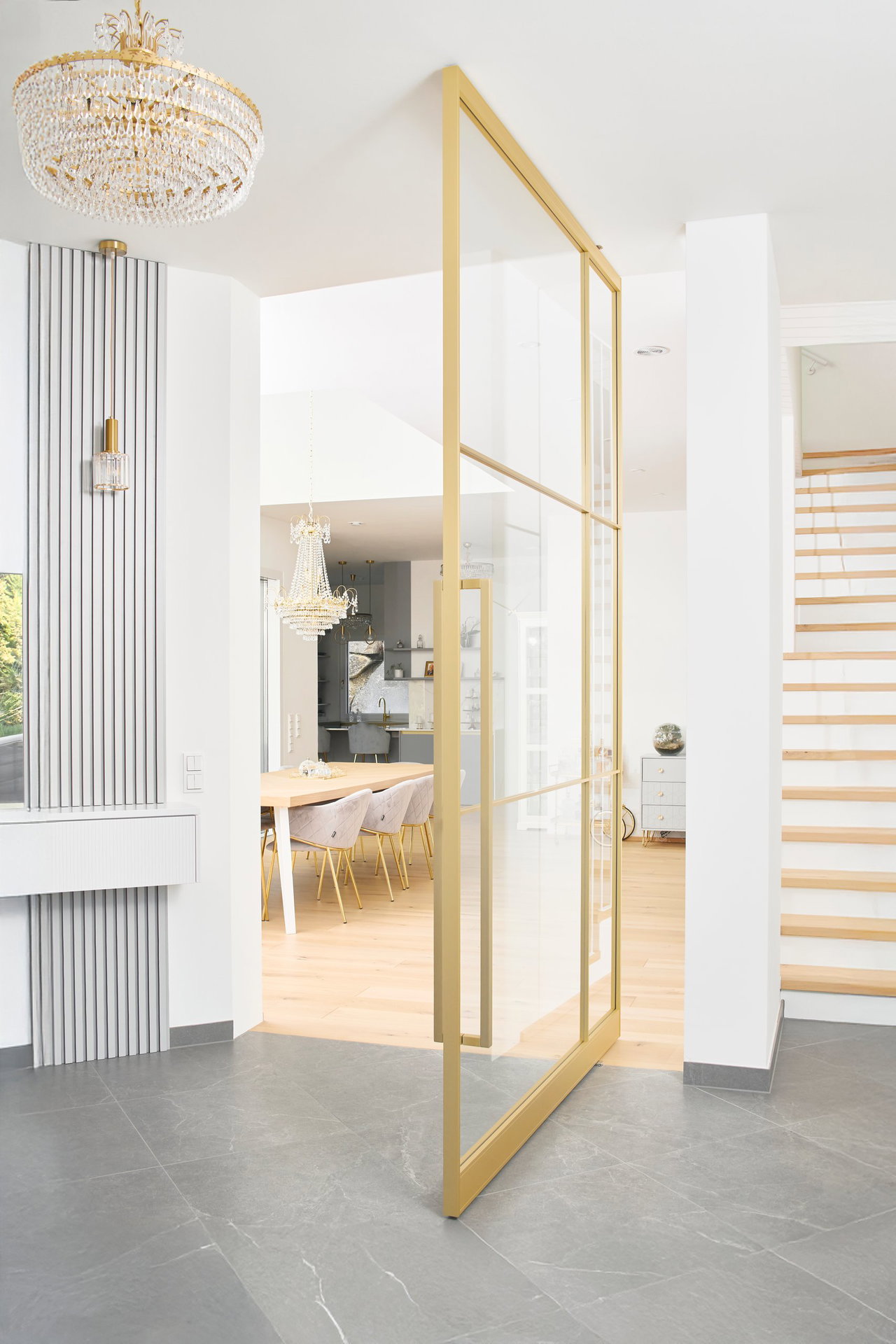 Steel and glass pivot door in a private home in Graz with FritsJurgens System M pivot hinge system inside