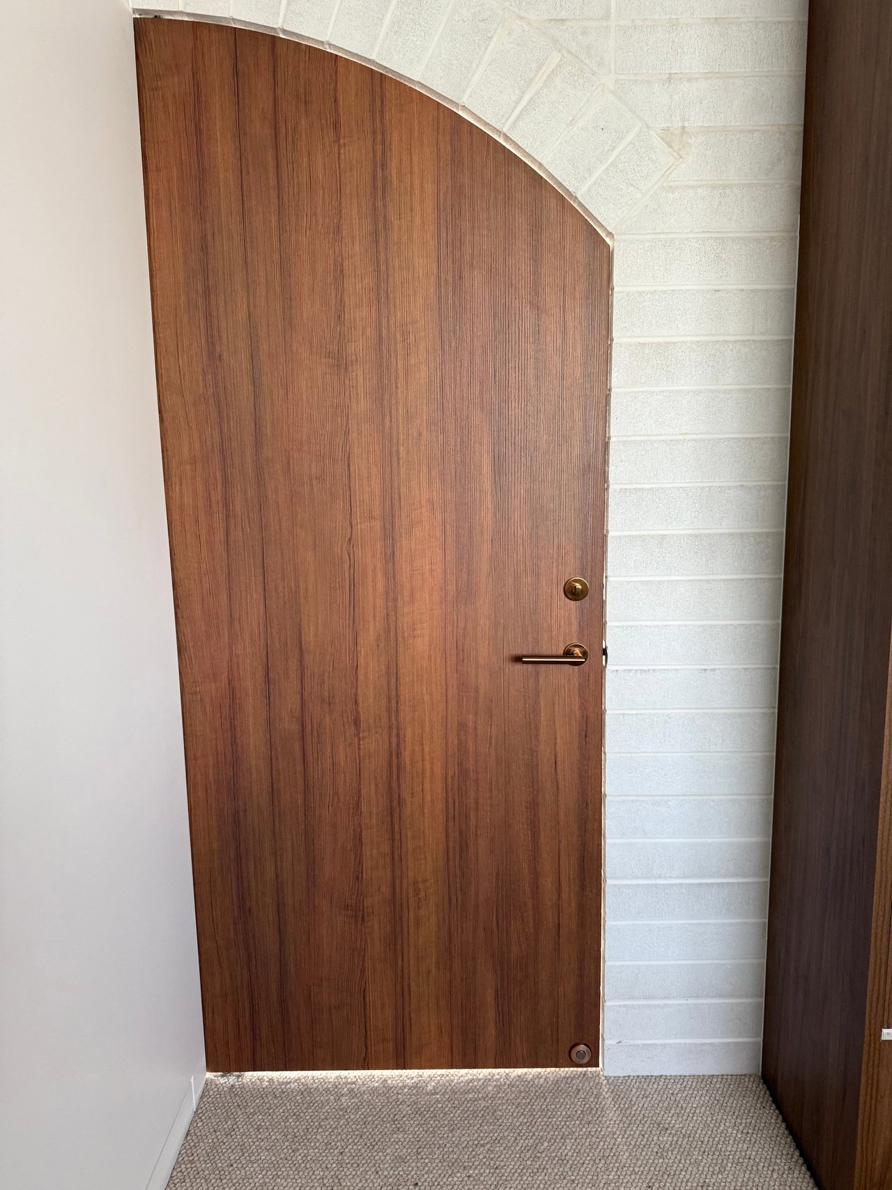 Wooden pivot door in a private home in Gold Coast with FritsJurgens System One pivot hinge system inside
