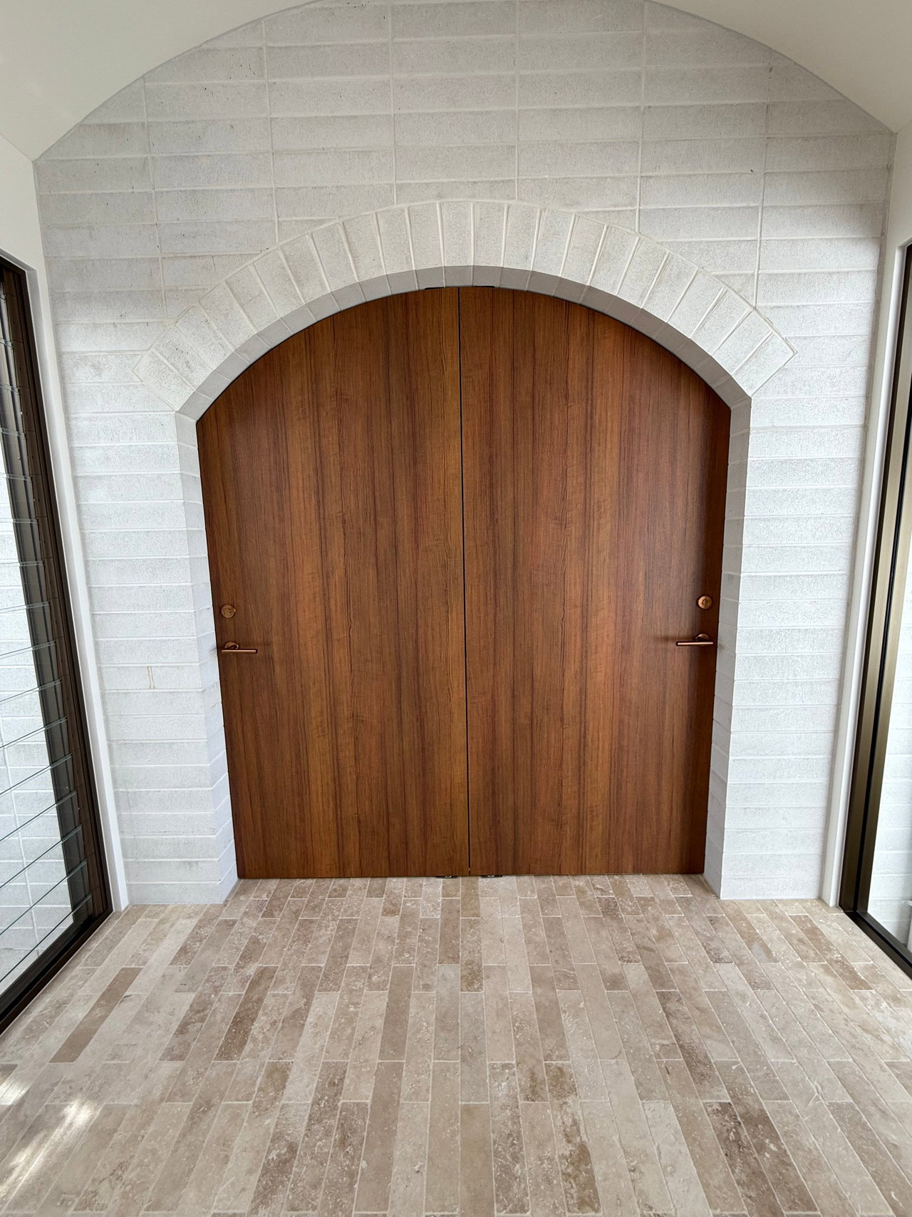 Wooden pivot door in a private home in Gold Coast with FritsJurgens System One pivot hinge system inside