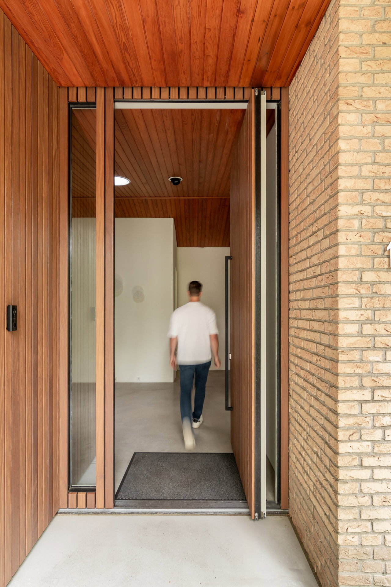 Wooden pivot door in a private home with FritsJurgens System M+ pivot hinge system inside