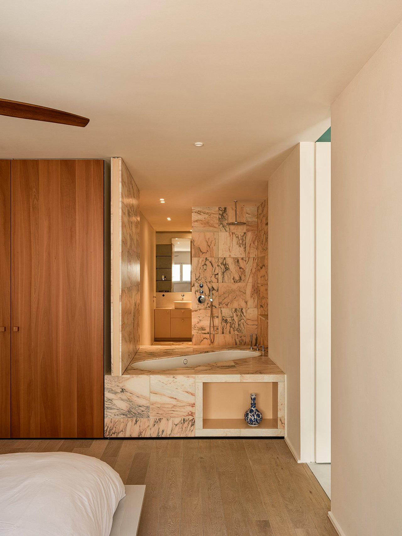 Stone pivot door in a private home in Antwerp with FritsJurgens System M+ pivot hinge system inside