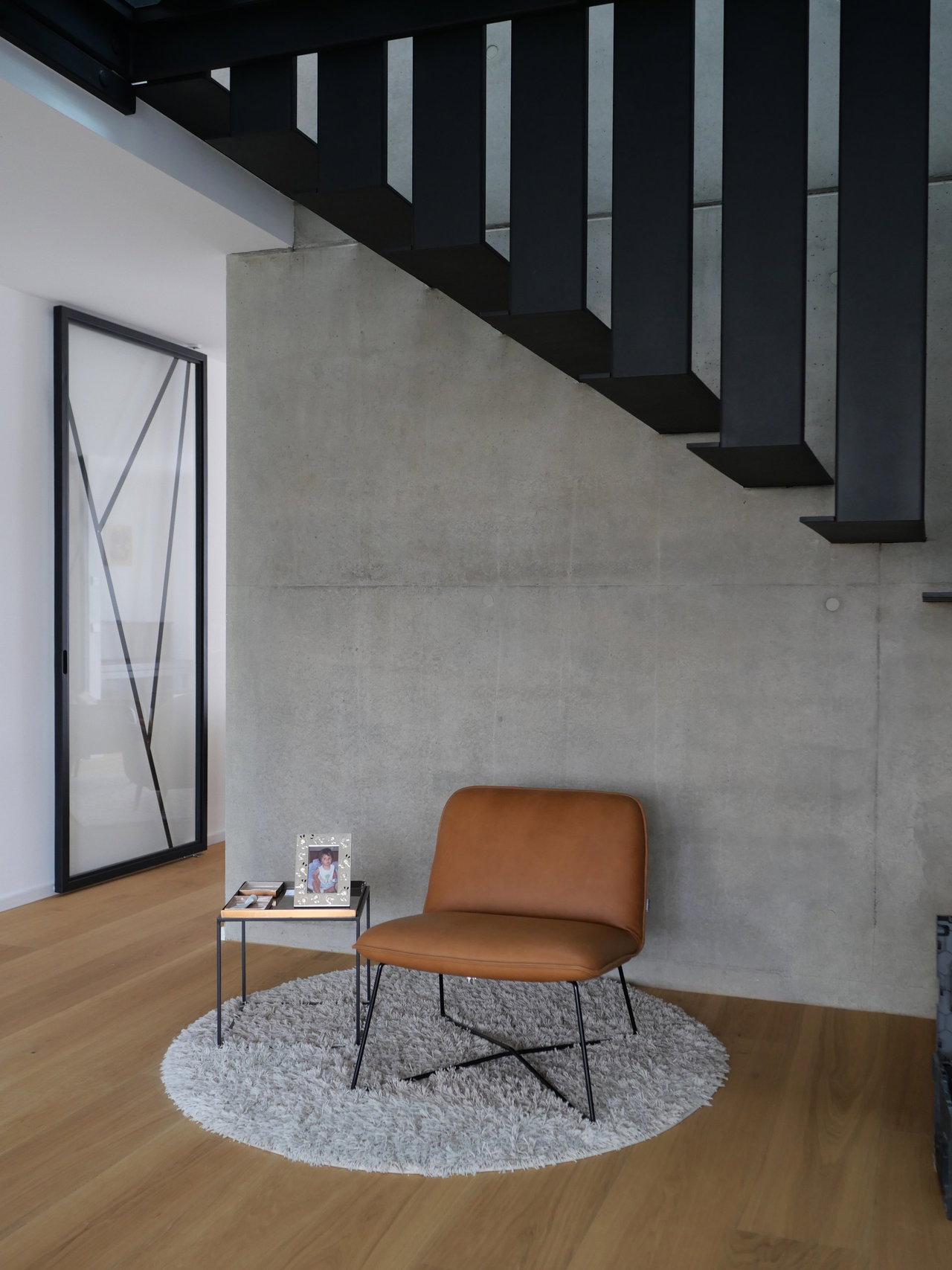 Steel and glass pivot door in a private home in Esch-sur-Alzette with FritsJurgens System One pivot hinge system inside