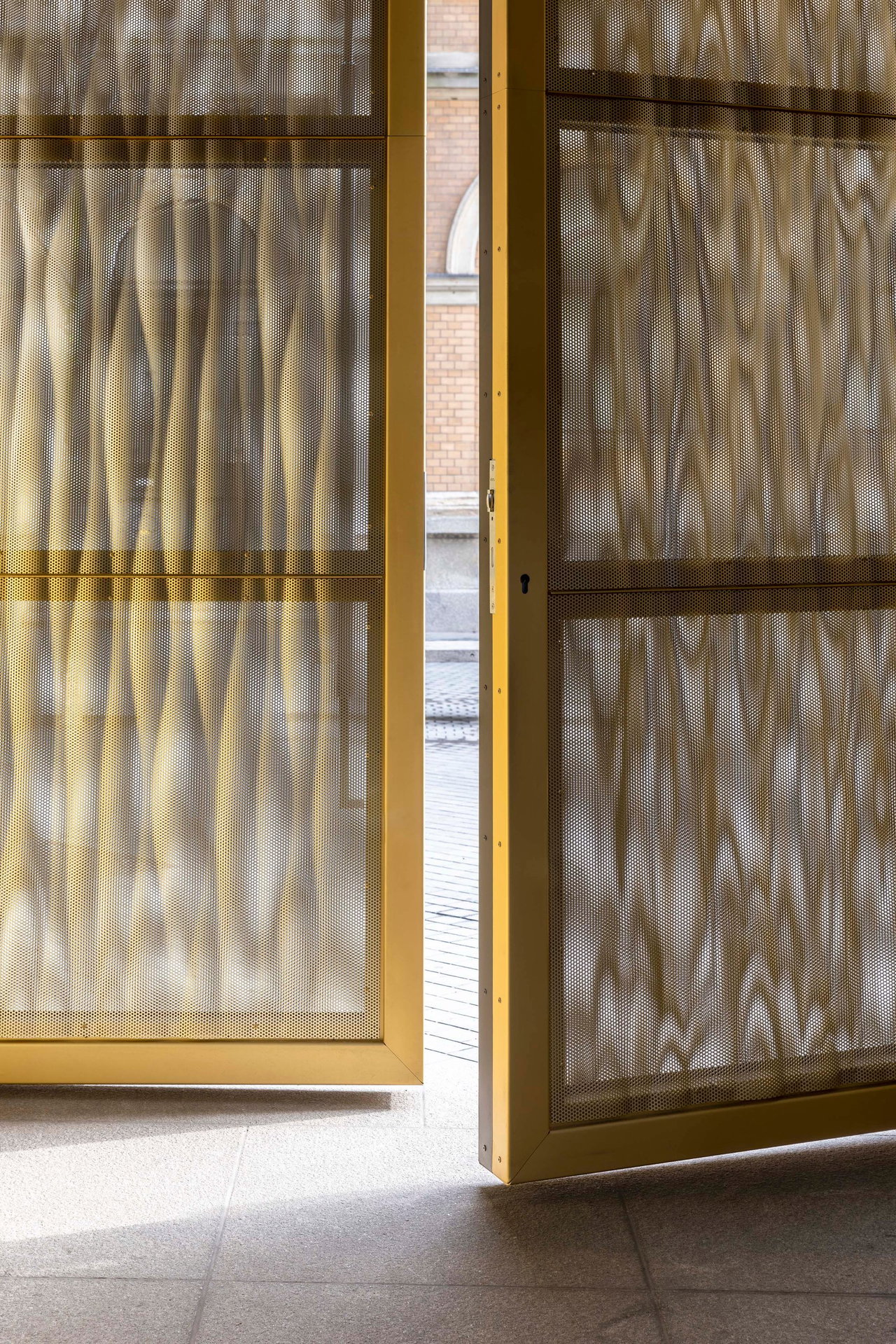 Aluminium pivot door in a religious building in Halle with FritsJurgens System M+ pivot hinge system inside