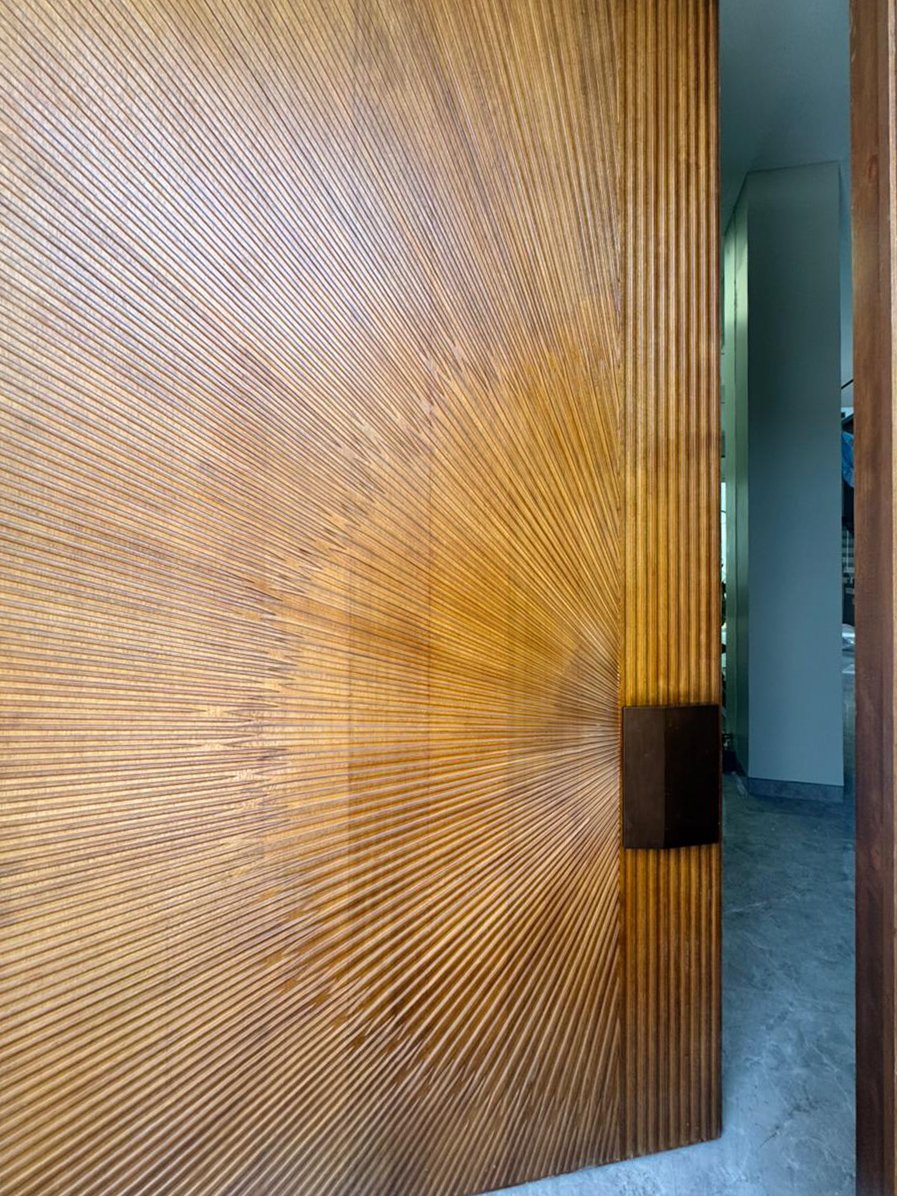 Wooden pivot door in a private home in Batam with FritsJurgens System One pivot hinge system inside