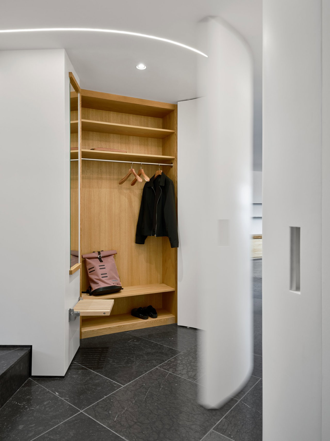 Wooden pivot door in a private home in Stockholm with FritsJurgens System M+ pivot hinge system inside