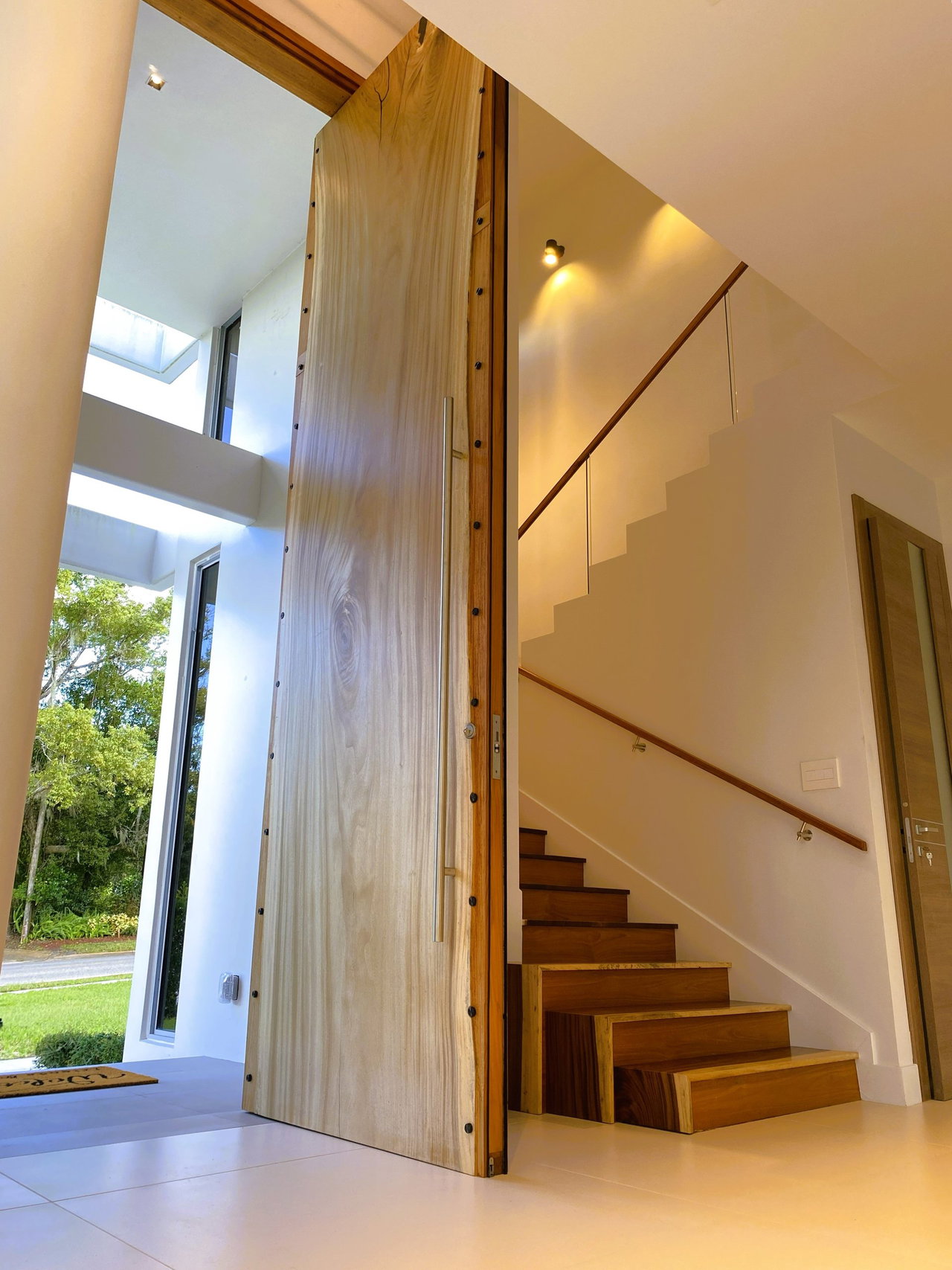 Wooden pivot door in a private home in Winter Park with FritsJurgens System M+ pivot hinge system inside