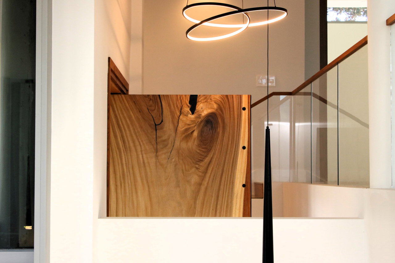 Wooden pivot door in a private home in Winter Park with FritsJurgens System M+ pivot hinge system inside