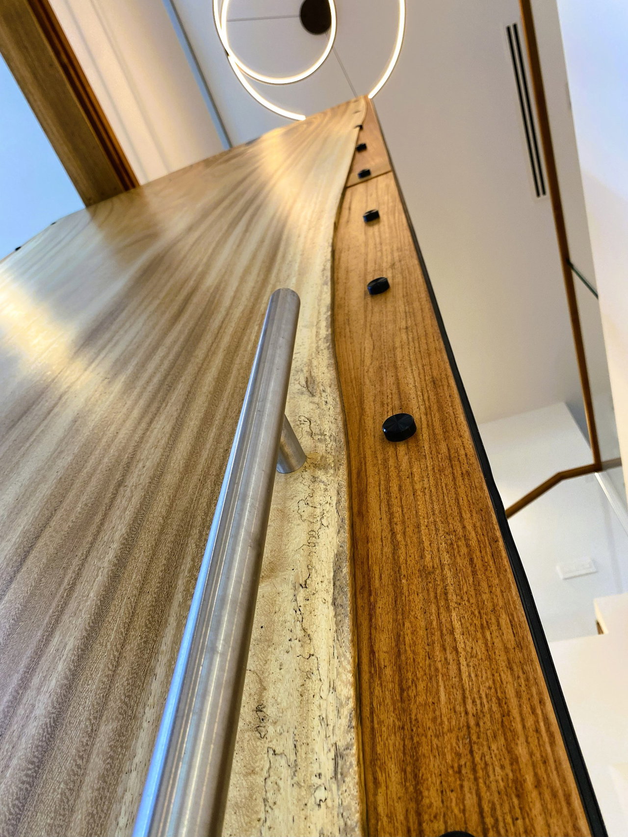 Wooden pivot door in a private home in Winter Park with FritsJurgens System M+ pivot hinge system inside