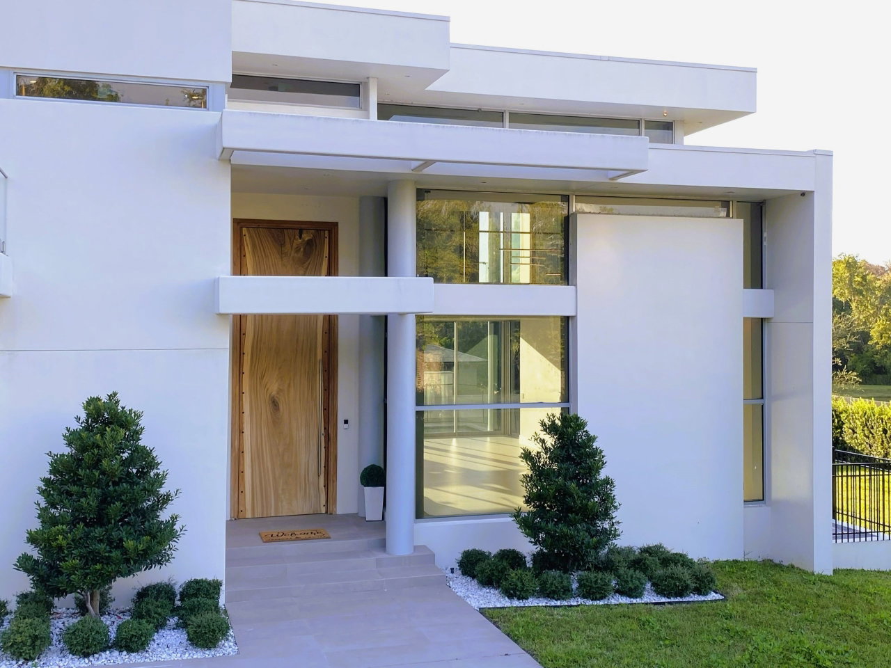 Wooden pivot door in a private home in Winter Park with FritsJurgens System M+ pivot hinge system inside