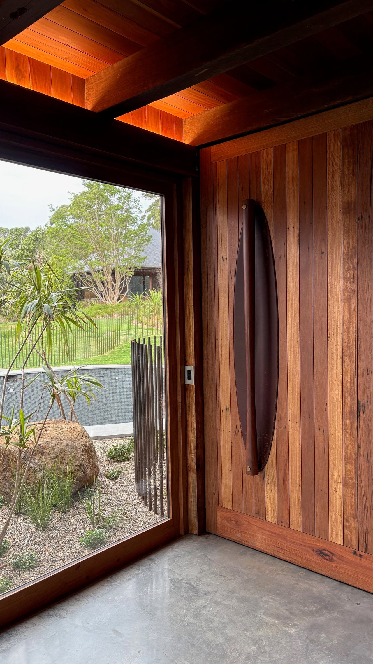Wooden pivot door in a private home in Saddleback Mountain, Illawarra with FritsJurgens System M+ pivot hinge system inside