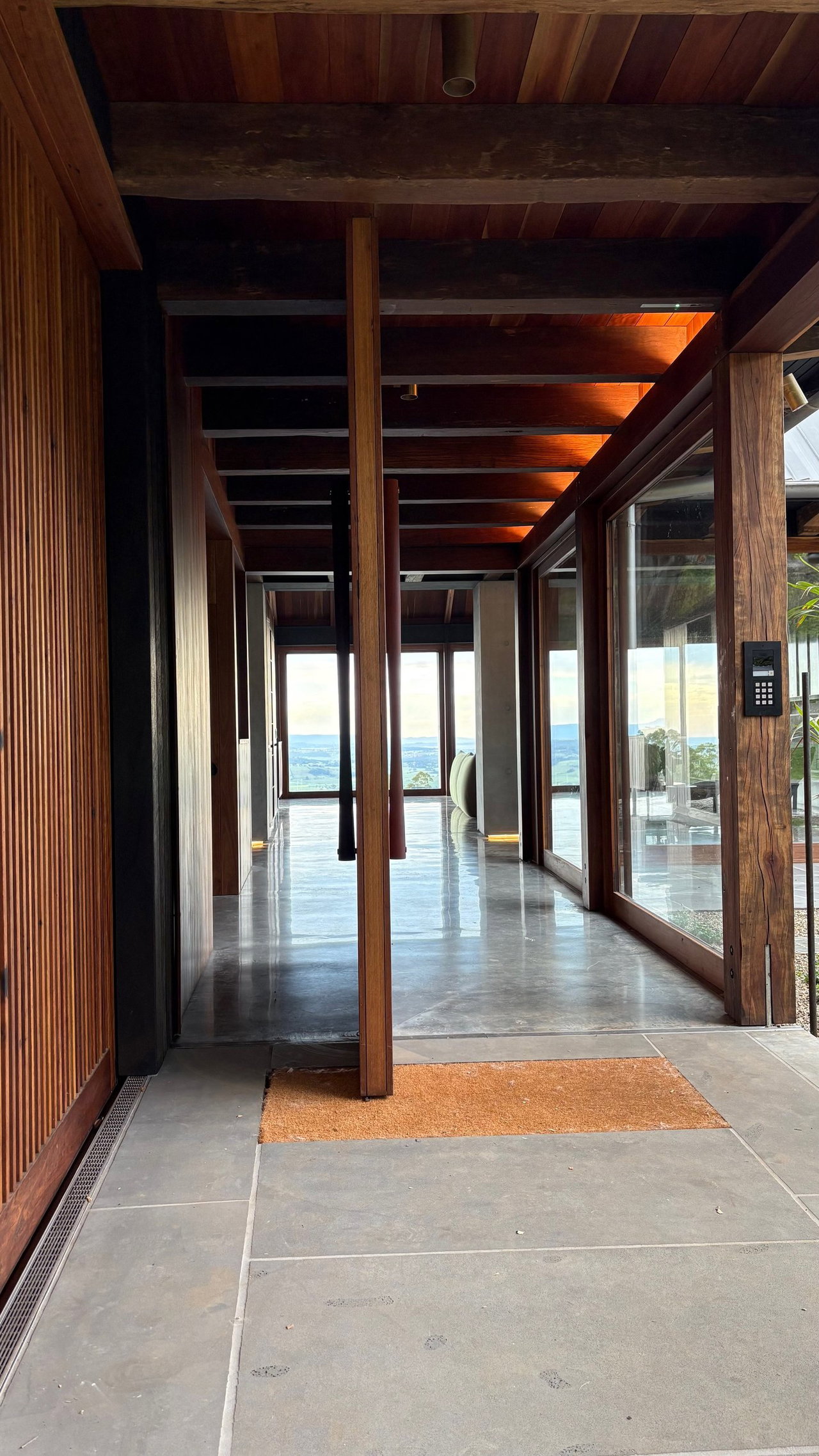 Wooden pivot door in a private home in Saddleback Mountain, Illawarra with FritsJurgens System M+ pivot hinge system inside