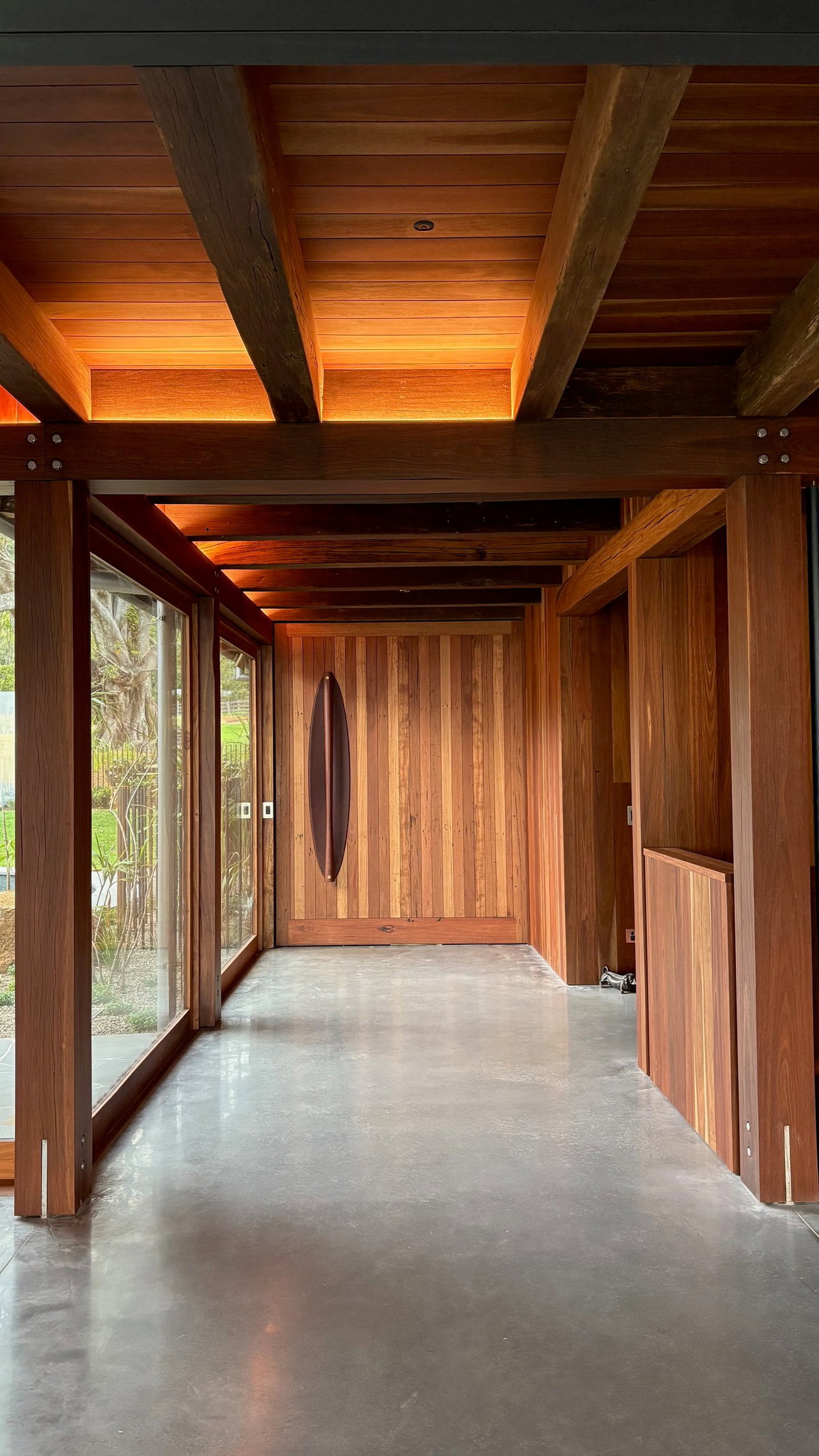 Wooden pivot door in a private home in Saddleback Mountain, Illawarra with FritsJurgens System M+ pivot hinge system inside