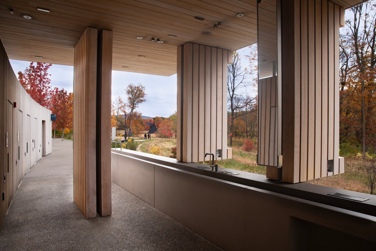 Wooden pivot door in a public building in New Windsor with FritsJurgens System One pivot hinge system inside