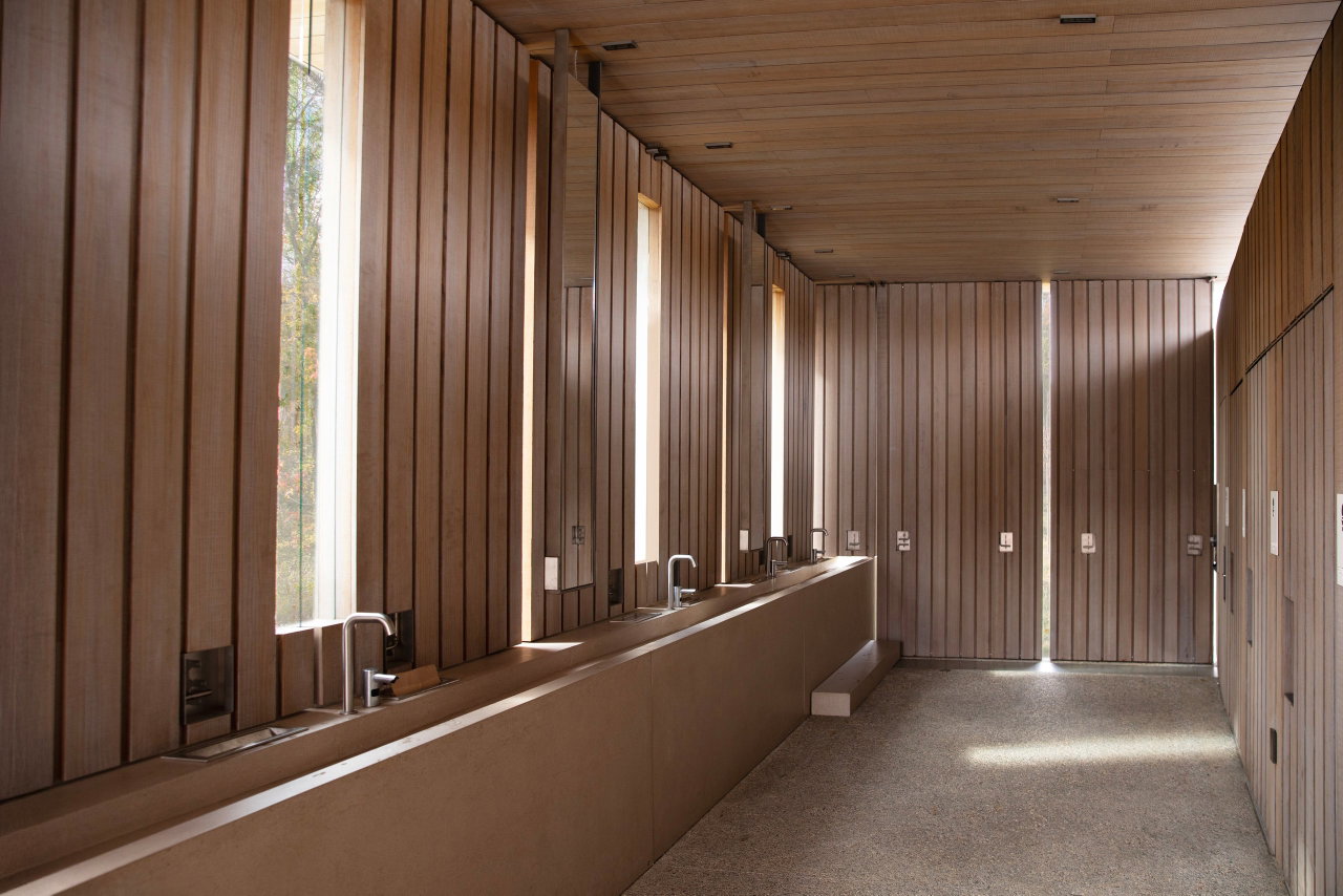 Wooden pivot door in a public building in New Windsor with FritsJurgens System One pivot hinge system inside