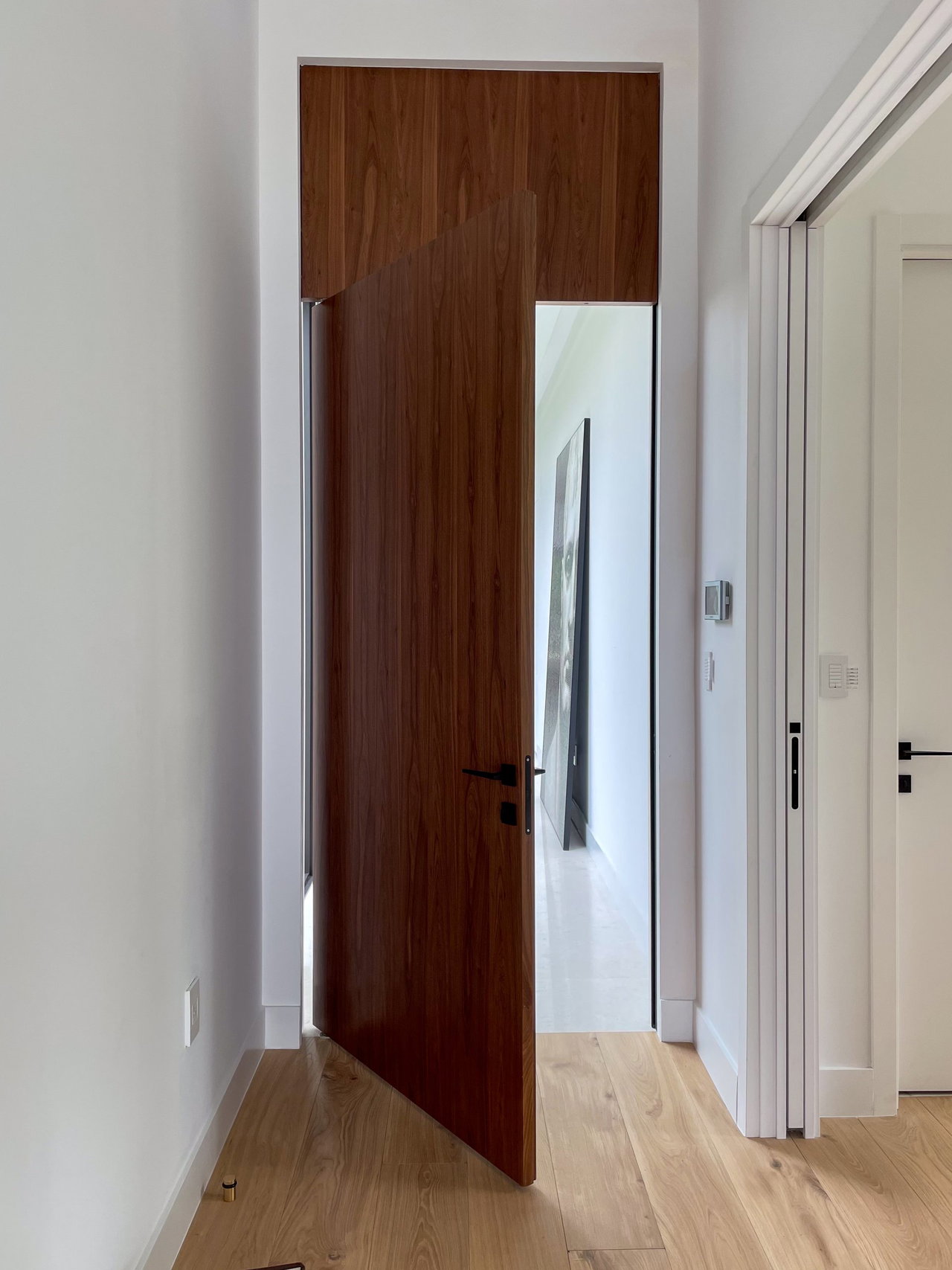 Wooden pivot door in a private home in Miami with FritsJurgens System One pivot hinge system inside