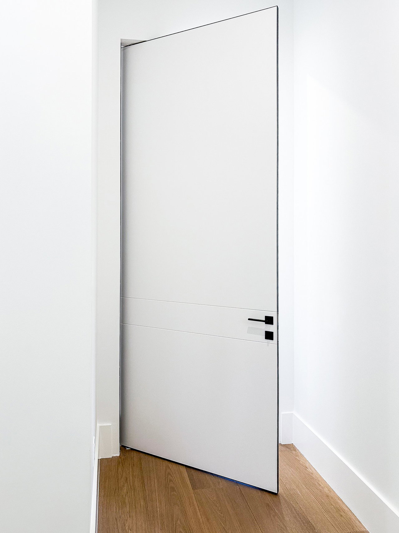 Aluminium pivot door in a private home in Naples, Florida with FritsJurgens System One pivot hinge system inside