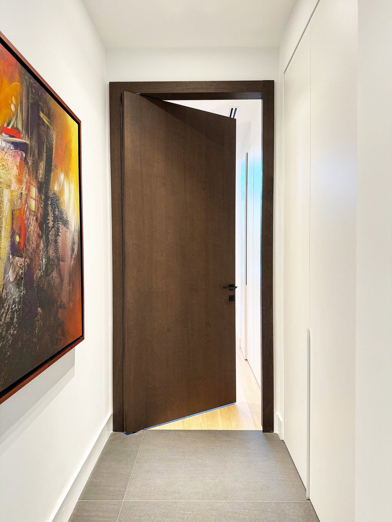 Wooden pivot door in a private home in North Miami Beach with FritsJurgens System One pivot hinge system inside
