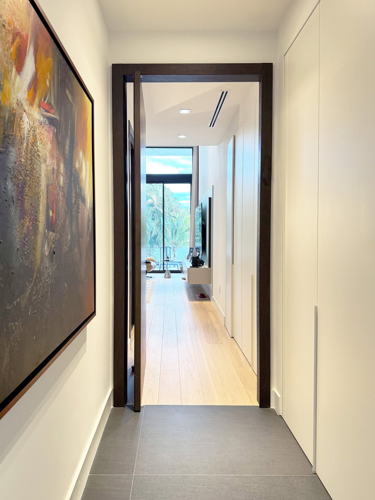 Wooden pivot door in a private home in North Miami Beach with FritsJurgens System One pivot hinge system inside