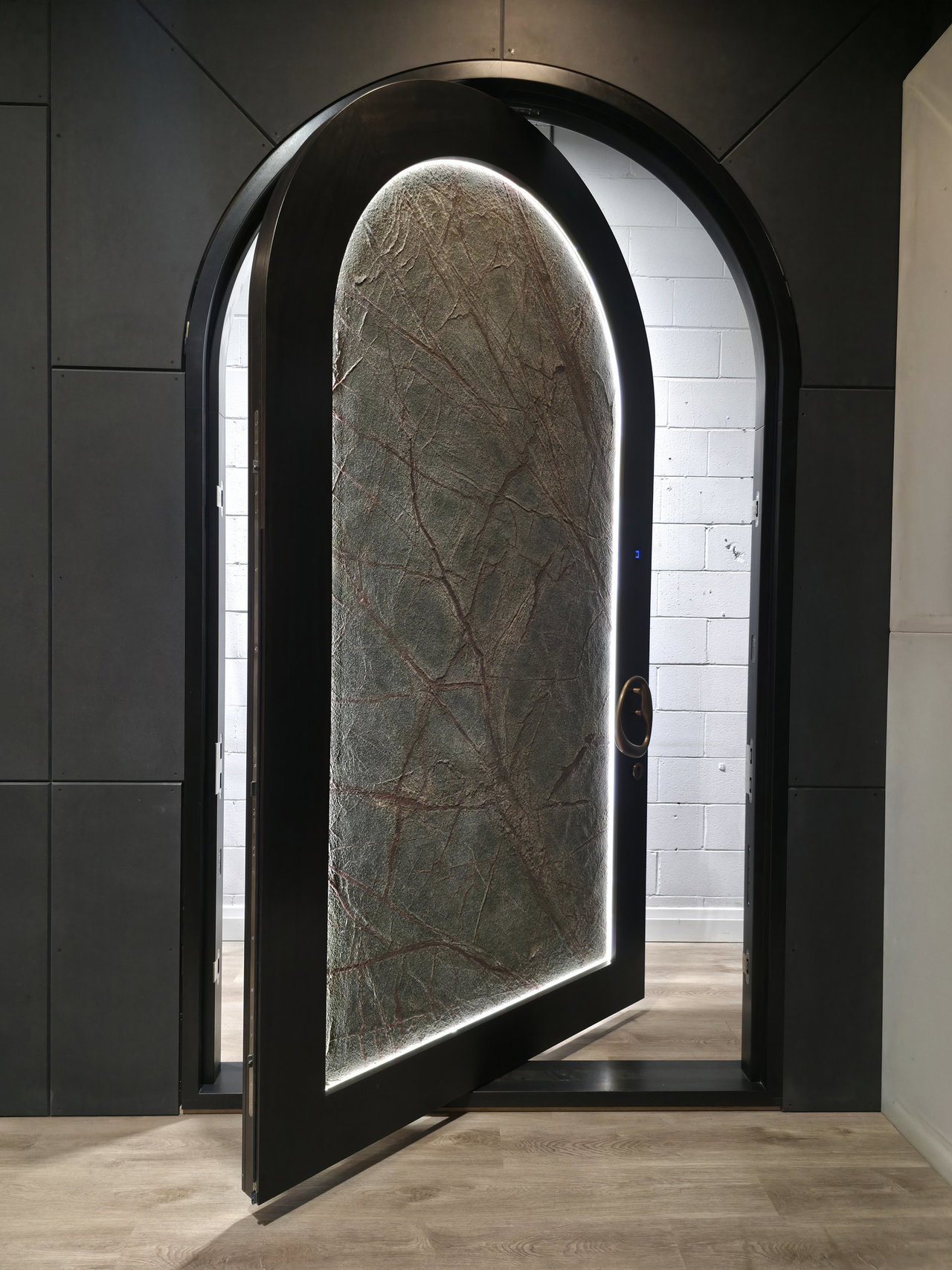 Stone pivot door in a private home in Los Angeles with FritsJurgens System M+ pivot hinge system inside