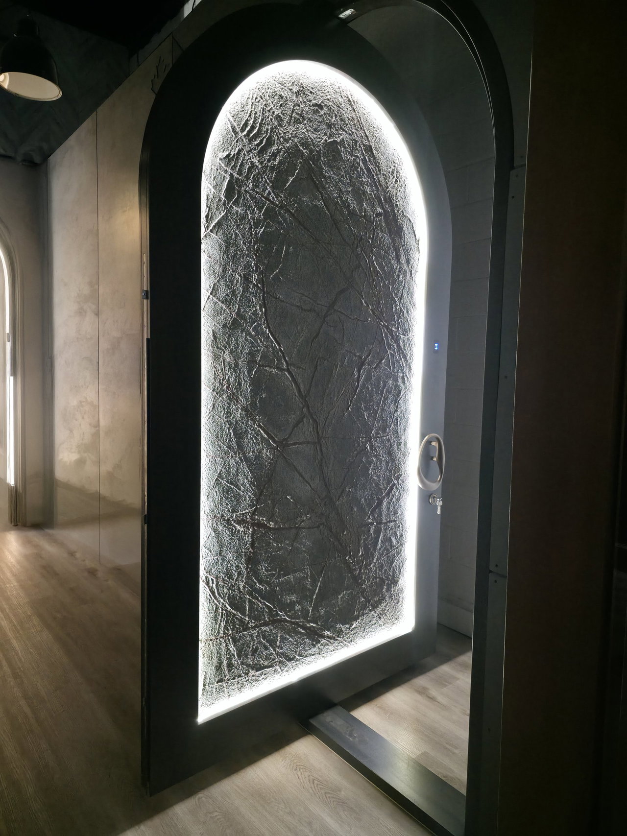 Stone pivot door in a private home in Los Angeles with FritsJurgens System M+ pivot hinge system inside