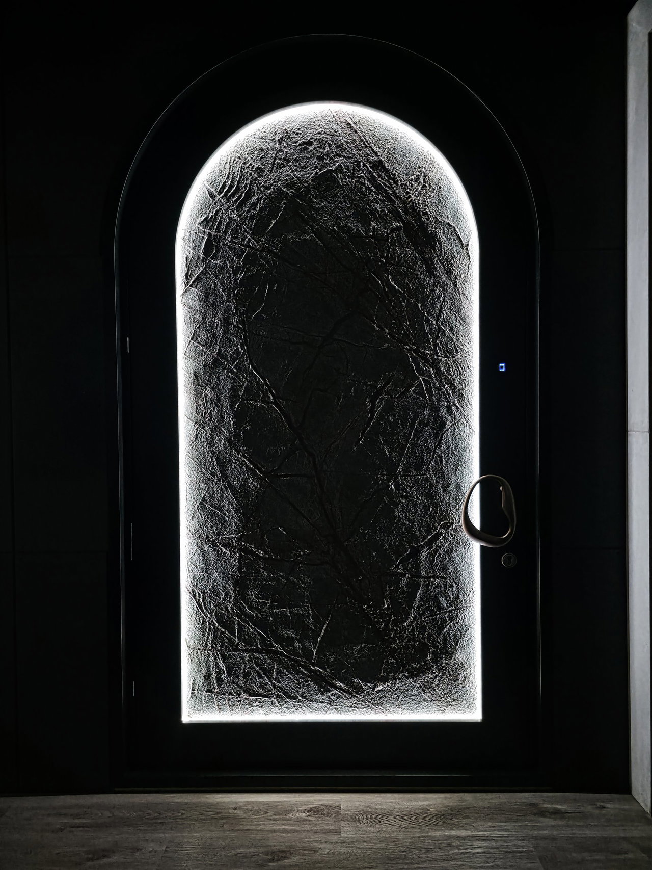 Stone pivot door in a private home in Los Angeles with FritsJurgens System M+ pivot hinge system inside