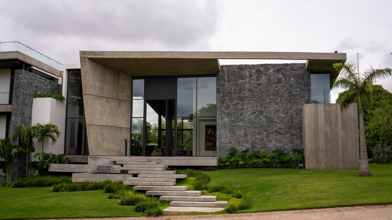 Stone pivot door in a private home in Santa Cruz de la Sierra with FritsJurgens System M+ pivot hinge system inside