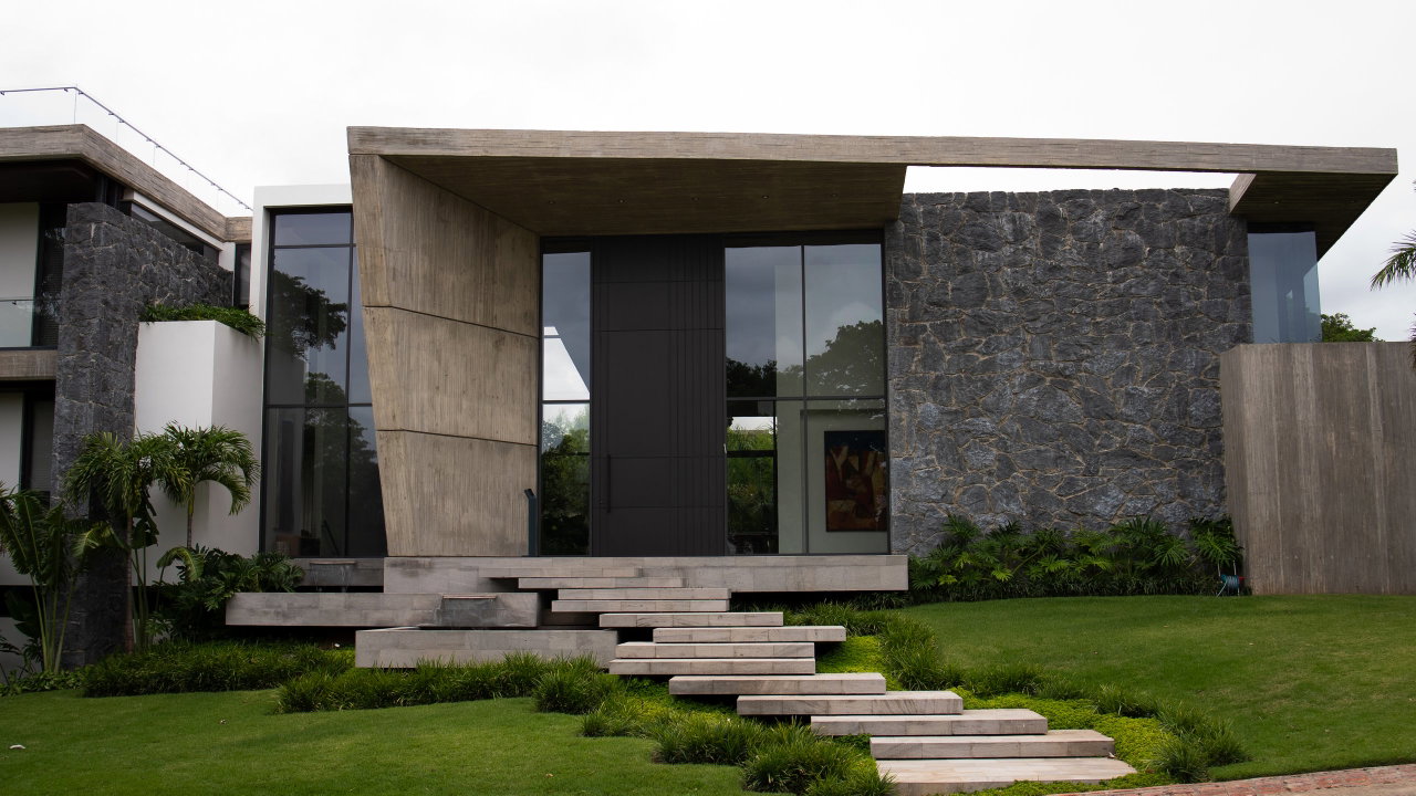 Stone pivot door in a private home in Santa Cruz de la Sierra with FritsJurgens System M+ pivot hinge system inside