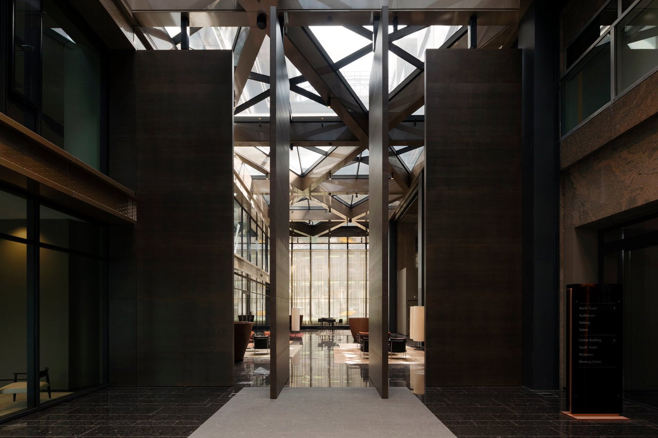Wooden pivot door in an office in Amsterdam with FritsJurgens System 3 pivot hinge system inside