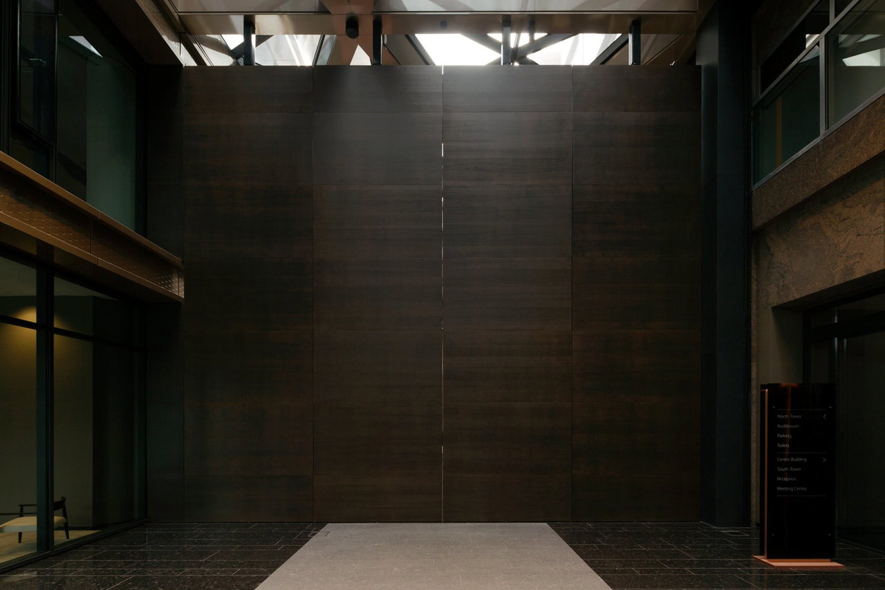 Wooden pivot door in an office in Amsterdam with FritsJurgens System 3 pivot hinge system inside