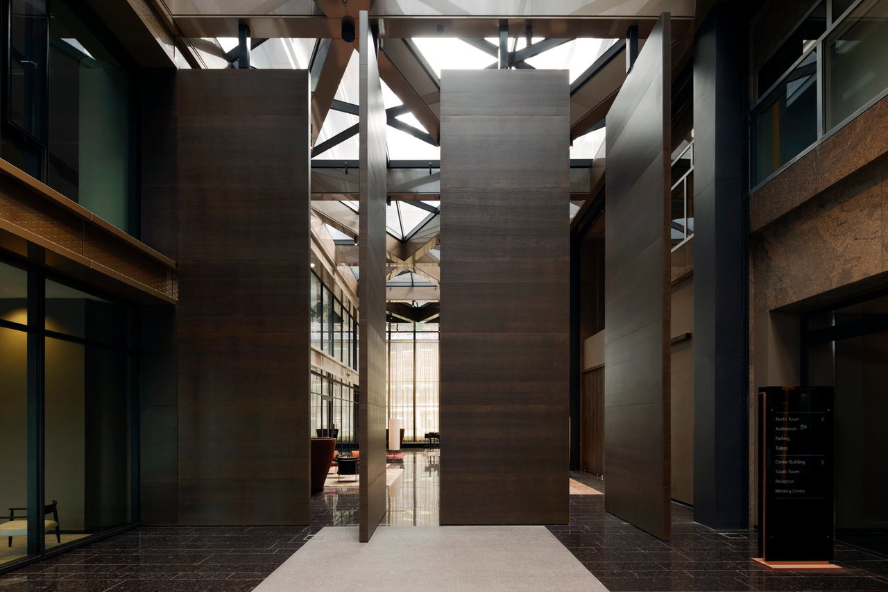 Wooden pivot door in an office in Amsterdam with FritsJurgens System 3 pivot hinge system inside