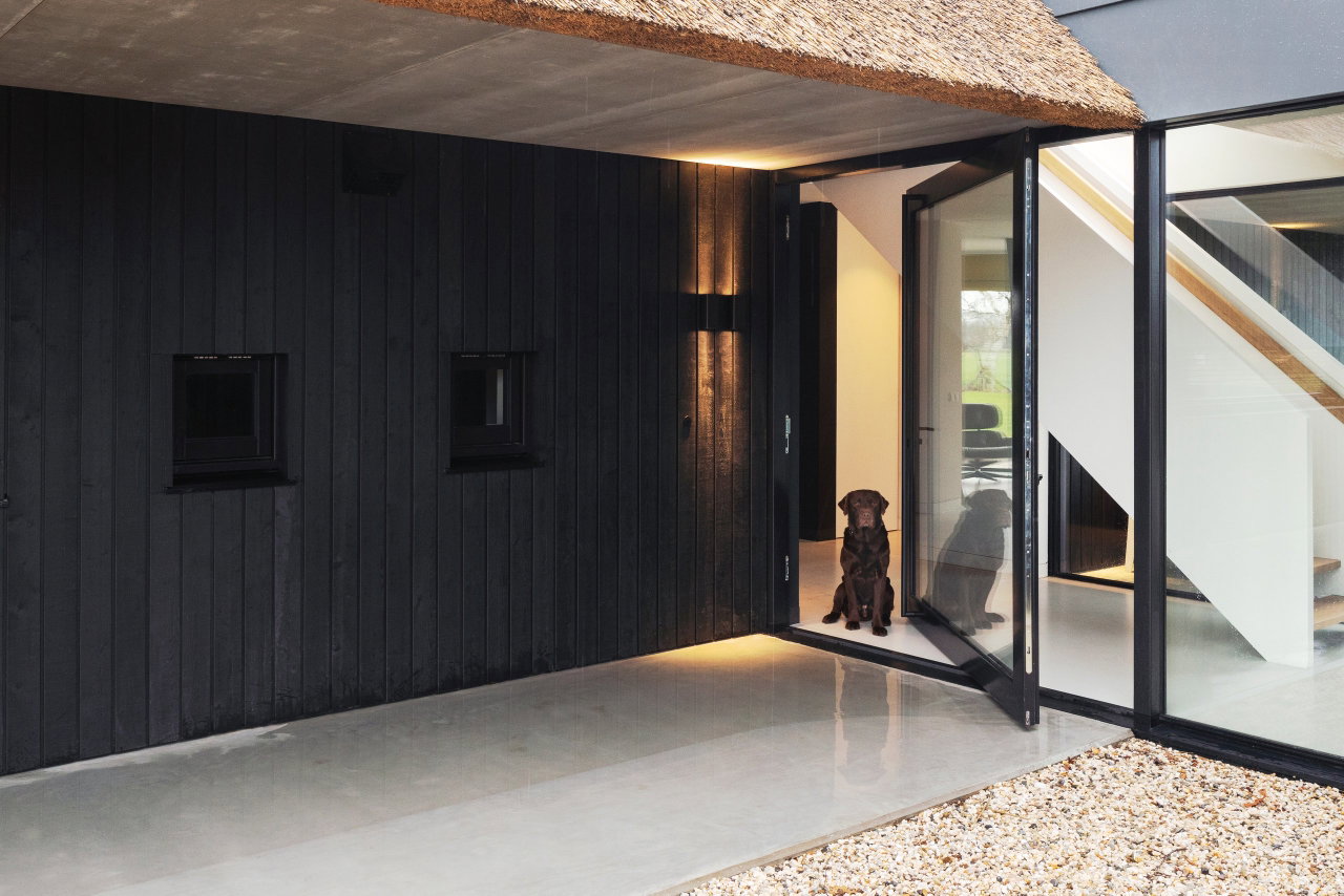 Wooden pivot door in a private home in Onnen with FritsJurgens System M pivot hinge system inside