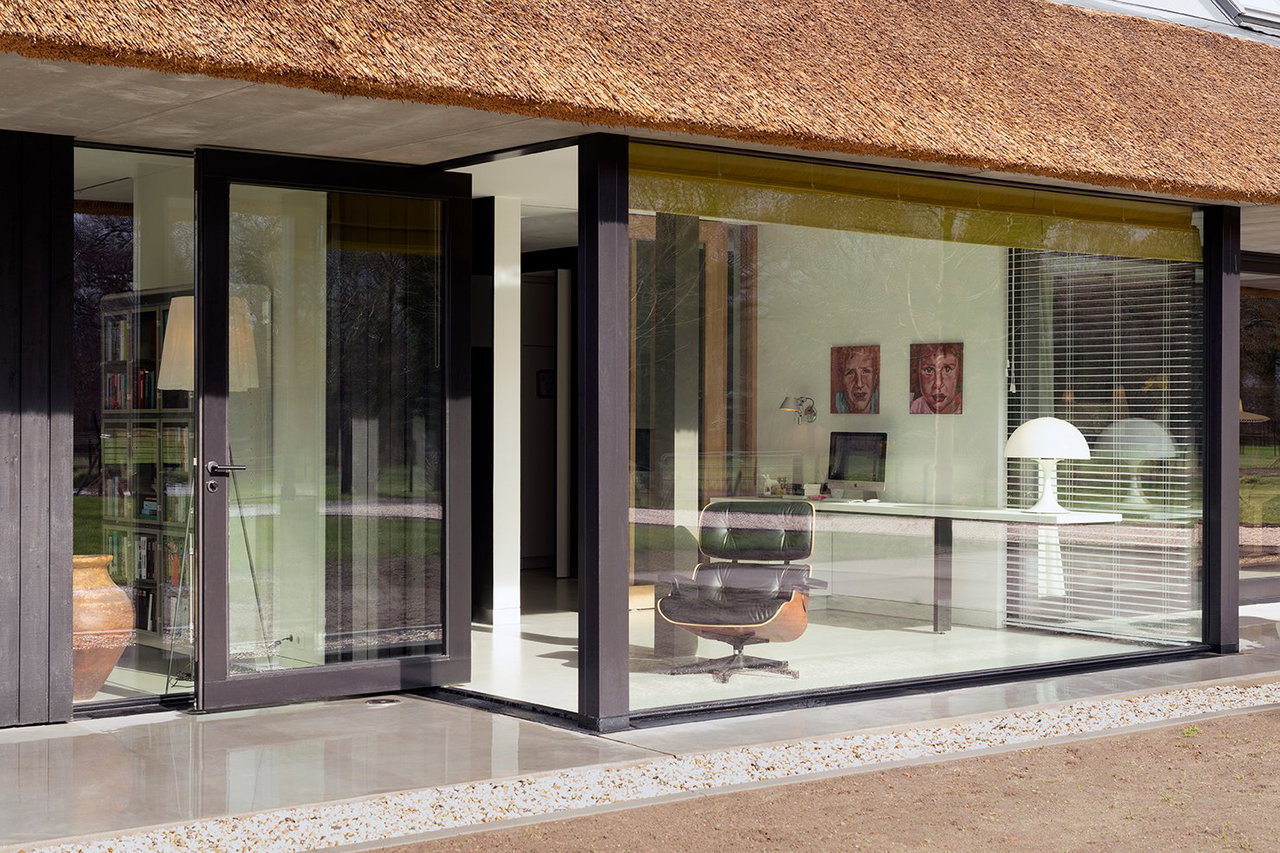 Wooden pivot door in a private home in Onnen with FritsJurgens System M pivot hinge system inside