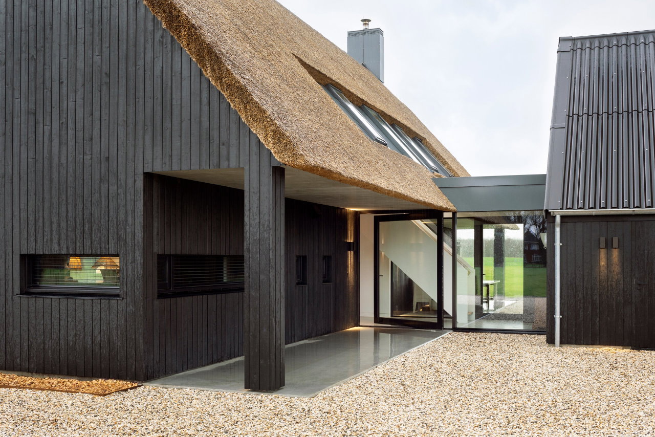 Wooden pivot door in a private home in Onnen with FritsJurgens System M pivot hinge system inside