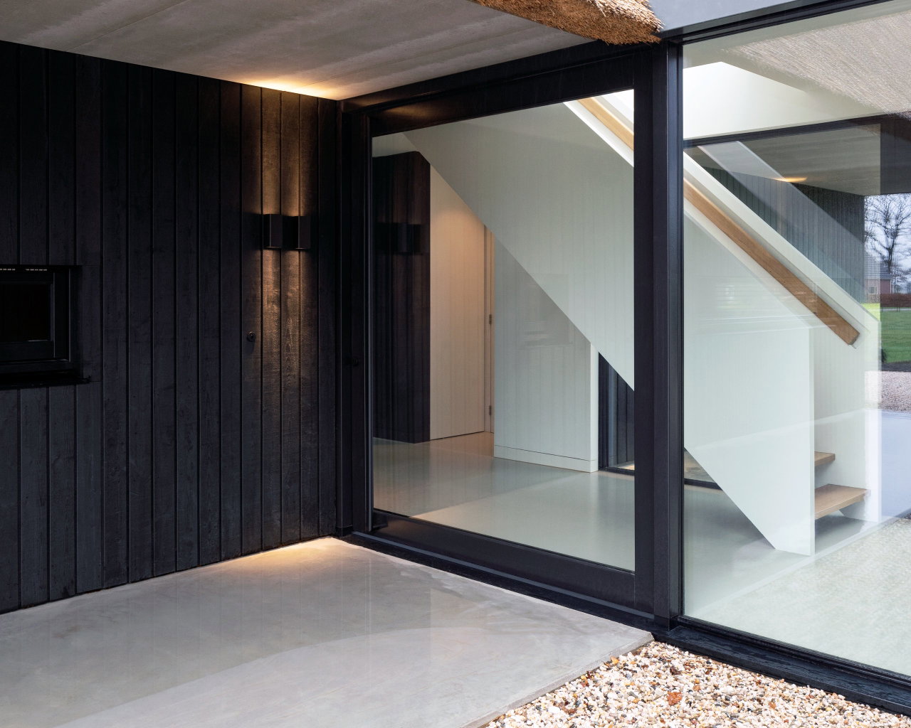Wooden pivot door in a private home in Onnen with FritsJurgens System M pivot hinge system inside