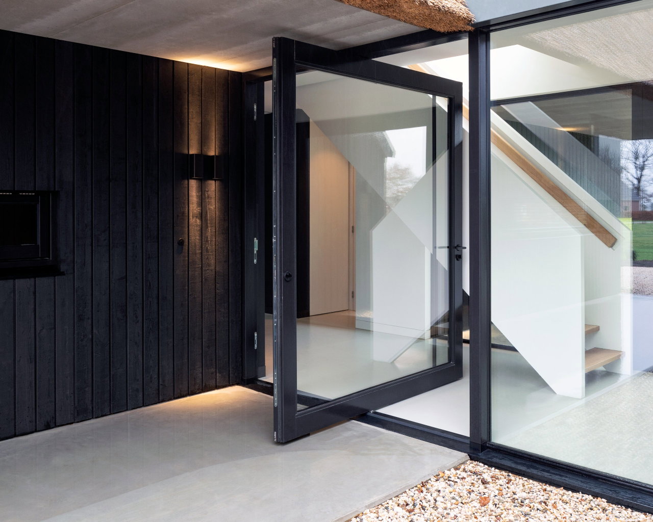 Wooden pivot door in a private home in Onnen with FritsJurgens System M pivot hinge system inside