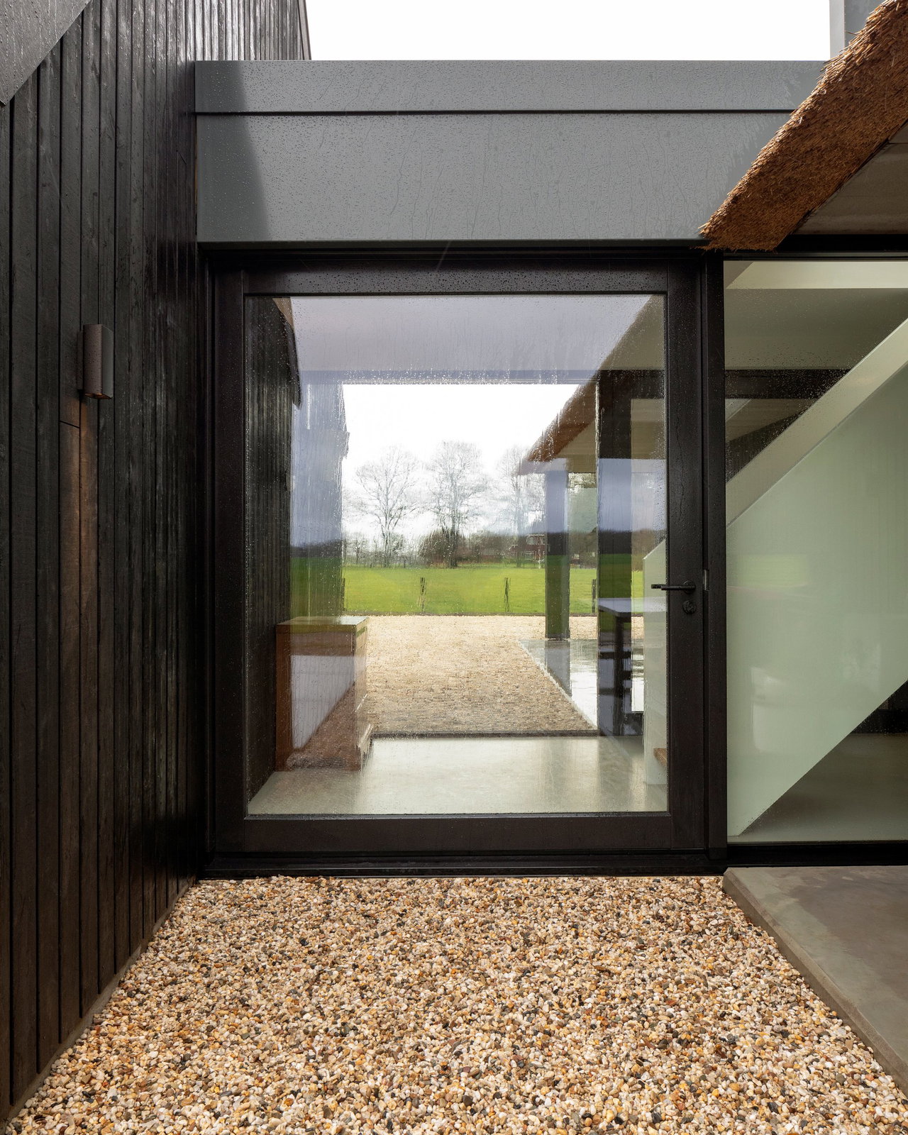 Wooden pivot door in a private home in Onnen with FritsJurgens System M pivot hinge system inside