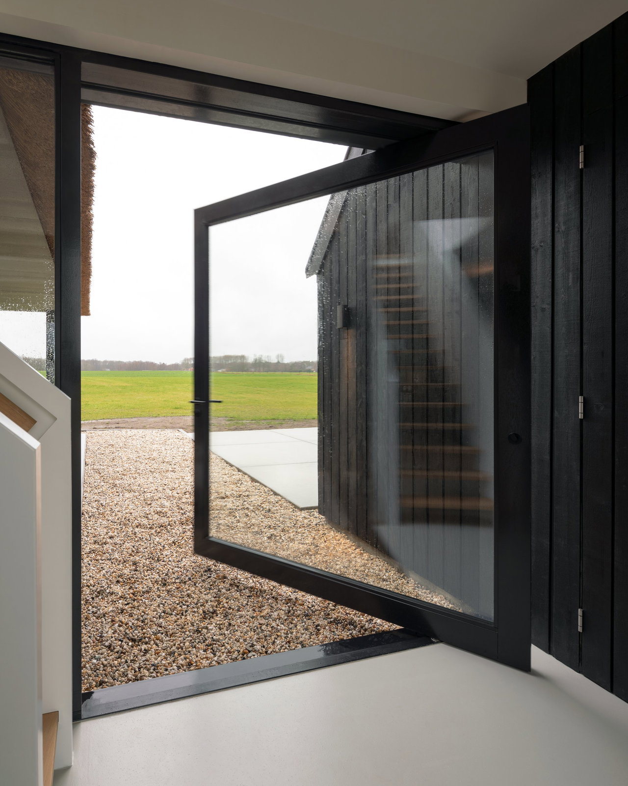 Wooden pivot door in a private home in Onnen with FritsJurgens System M pivot hinge system inside