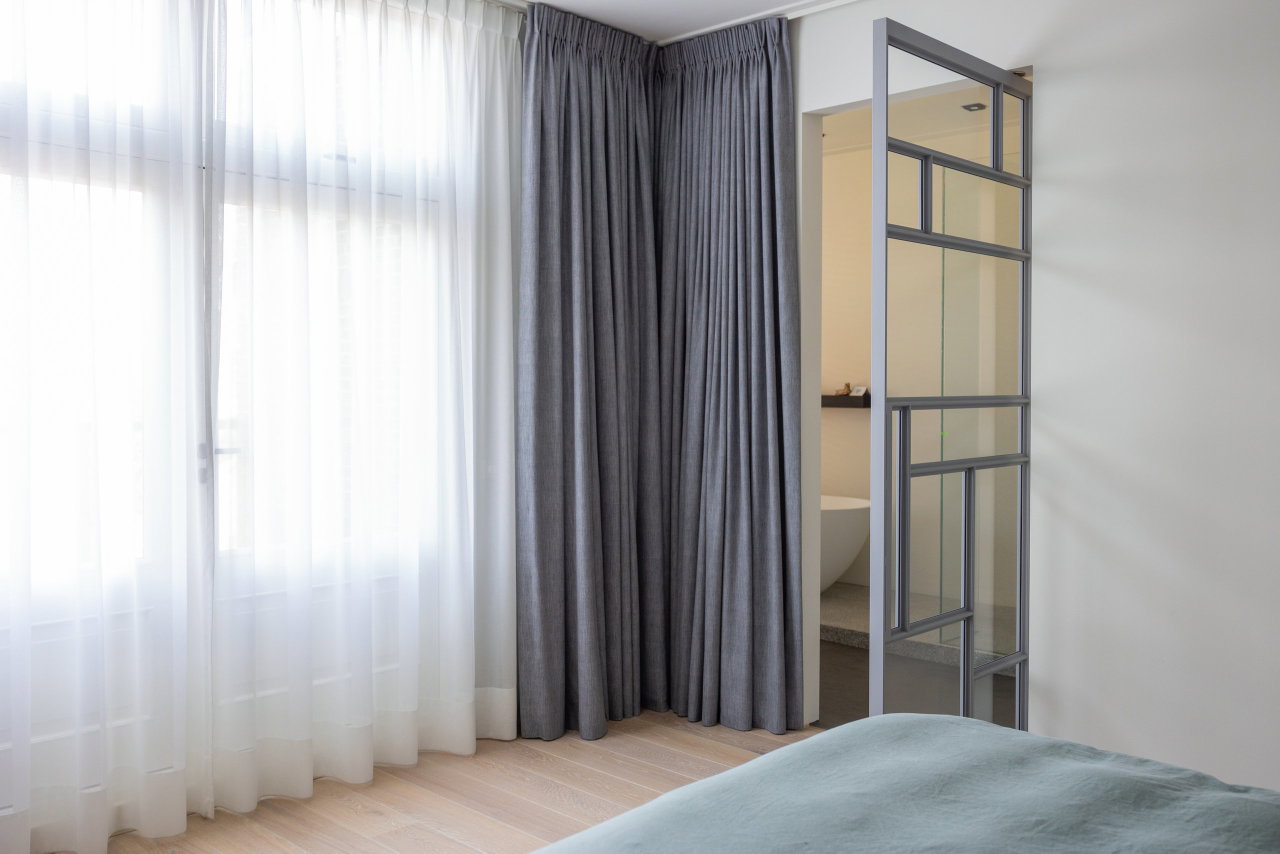 Pivottür aus Stahl und Glas in einem Privathaus in Utrecht mit FritsJurgens System M Pivot-Scharniersystem im Inneren