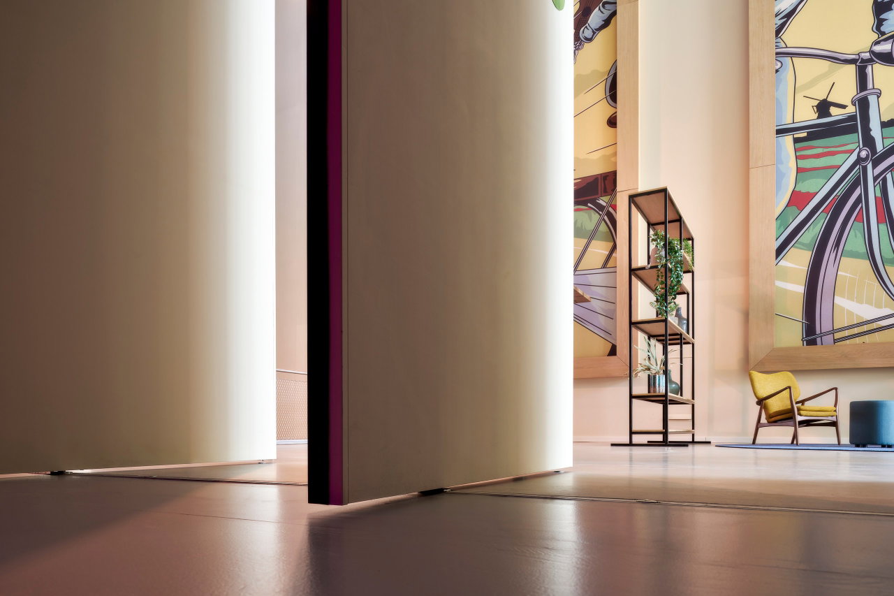 Wooden pivot door in a public building in Amsterdam with FritsJurgens System M pivot hinge system inside