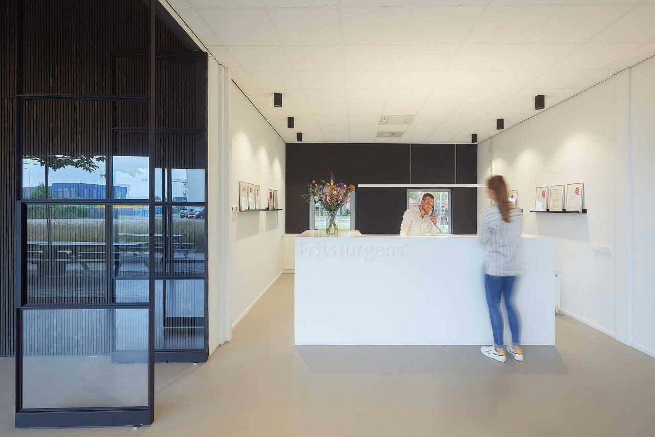 Steel and glass pivot door in an office in Kolham with FritsJurgens System One pivot hinge system inside