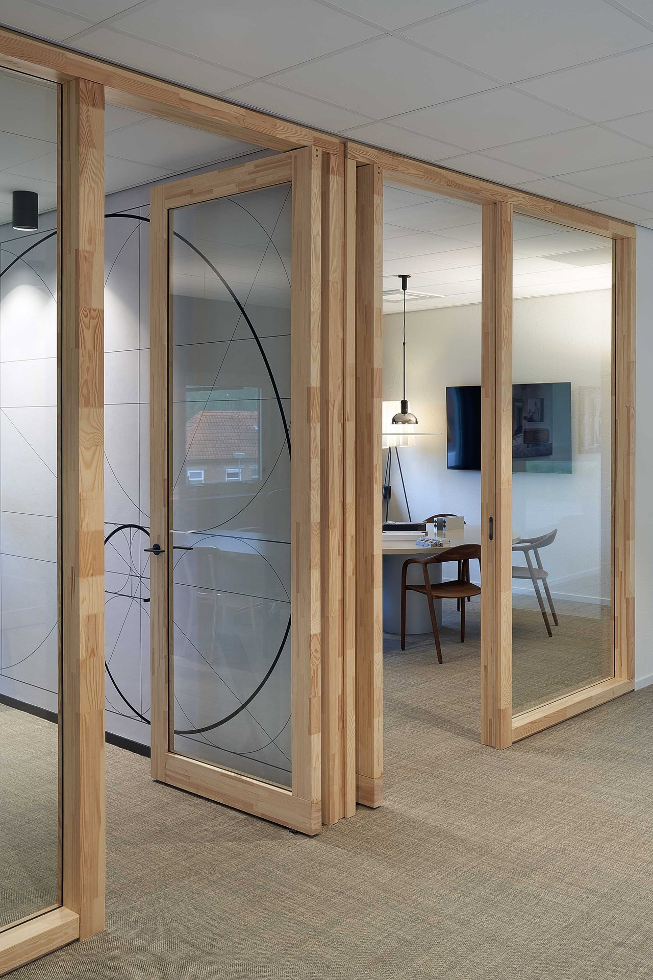 Steel and glass pivot door in an office in Kolham with FritsJurgens System One pivot hinge system inside
